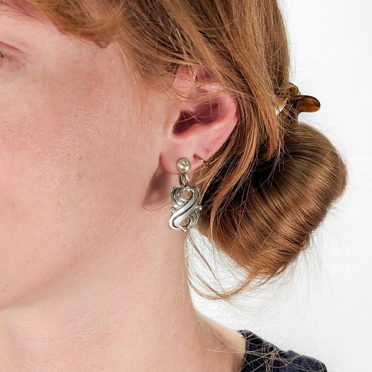 A fine pair of signed Mexican sterling silver earrings.

Designed by Hector Aguilar for Talla Borda.

With screw back closures.

Simply wonderful Aguilar design!

Date:
20th Century

Overall Condition:
They are in overall good, as-pictured, used