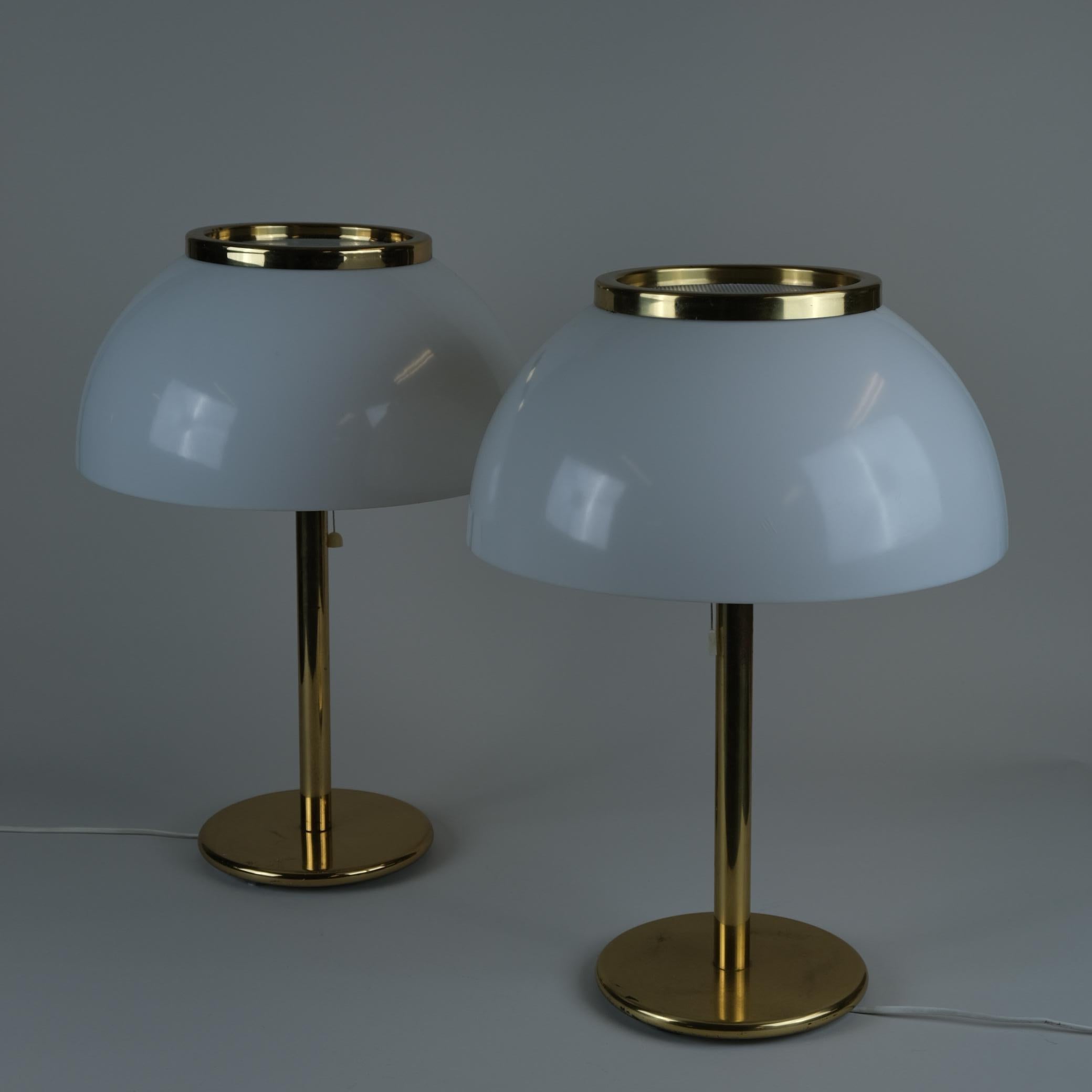 A pair of large table lamps from the Senior series designed by Heikki Turunen and manufactured by Orno Oy in the 1970s in Finland. The lamps feature a brass body topped with white metal and an acrylic dome shaped shades. Both lamps are in good