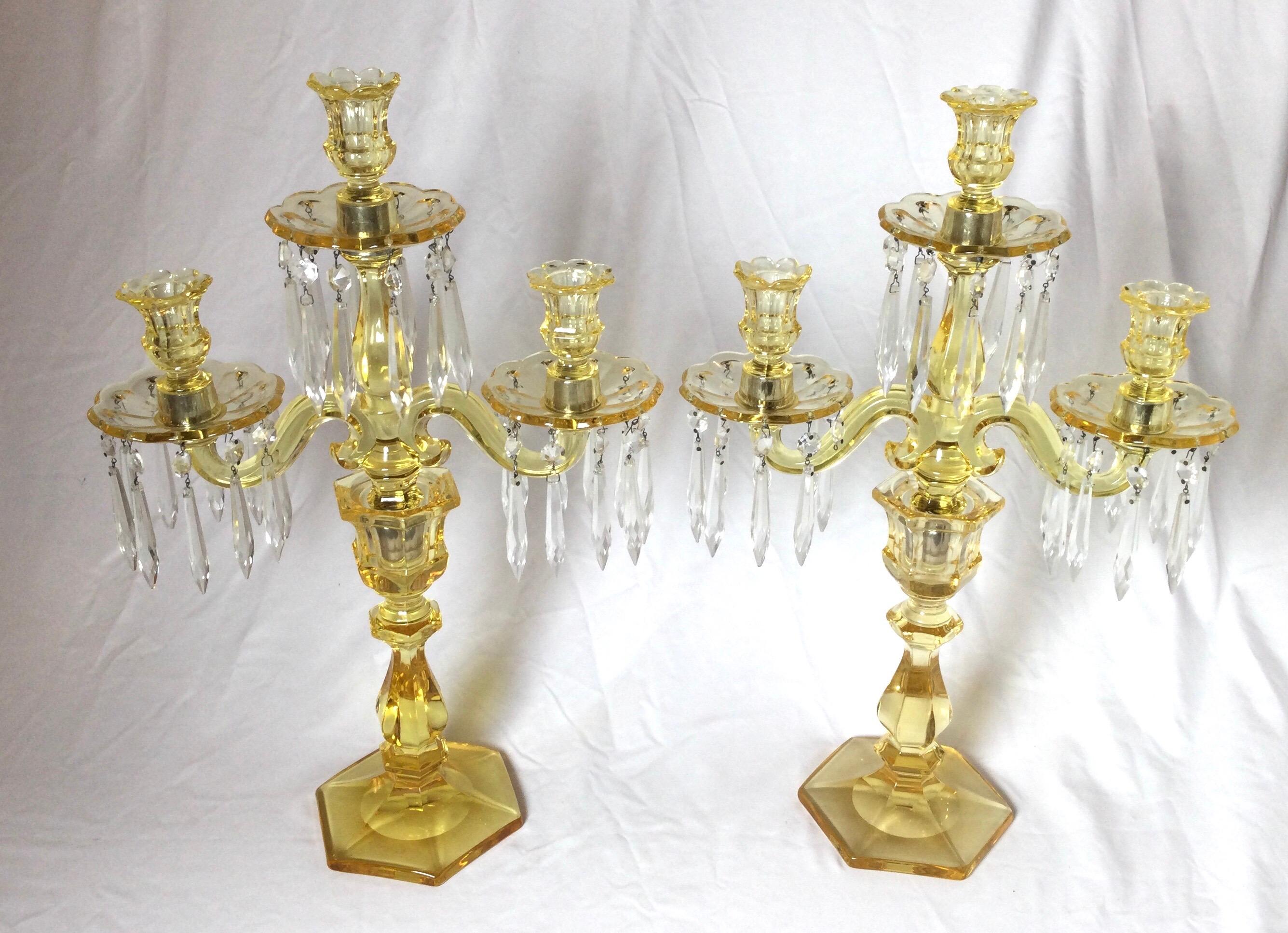 Elegant pair of Heisey glass three light candelabra in yellow. The base, center column and arms in yellow glass with clear faceted small spears all around the bobeches.