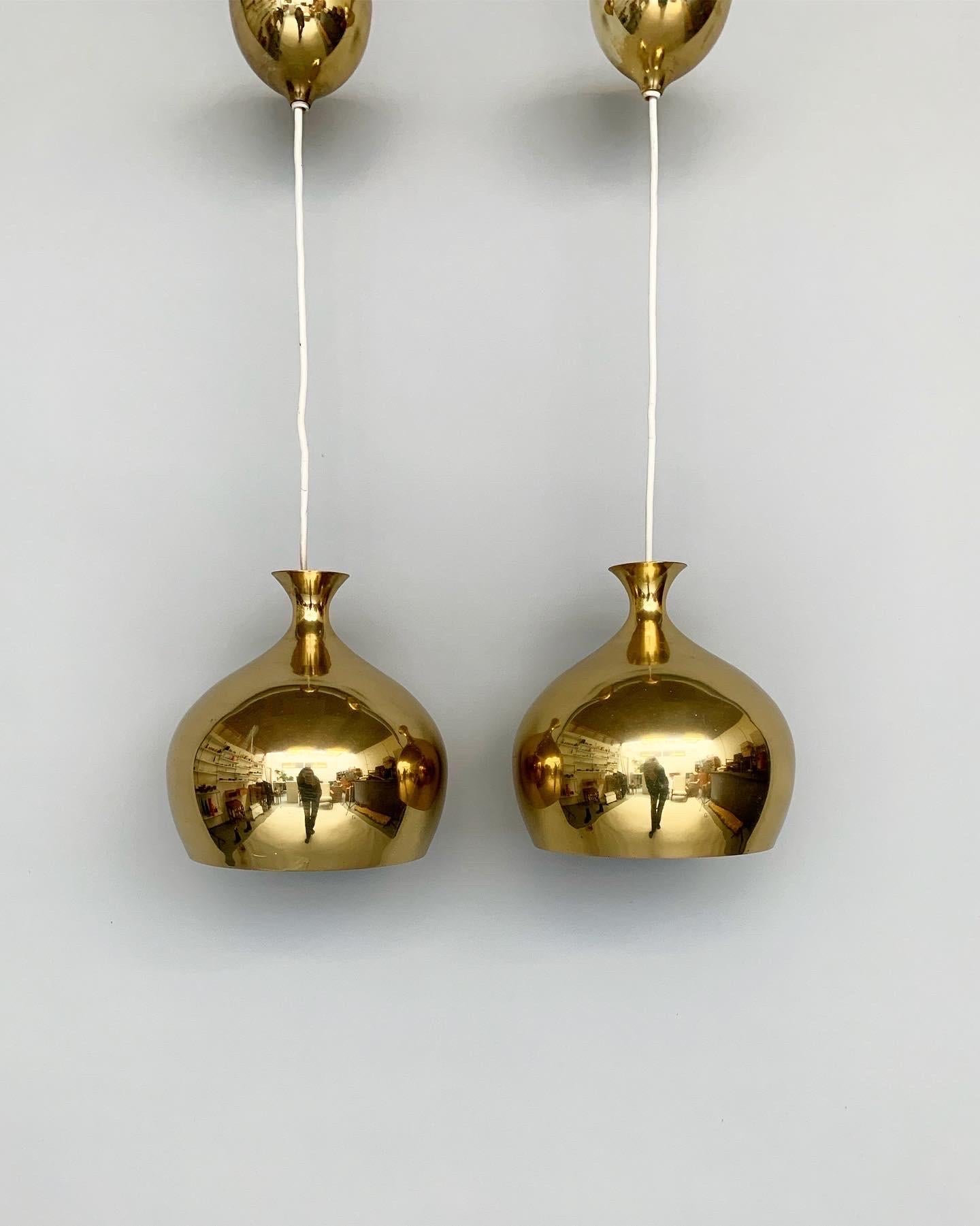 Pair of Helge Zimdal ‚onion‘ pendant lights for Falkenbergs Belysnings, a lighting company based in Sweden in the 1960s.

Made of solid brass with matching brass canopies, beautiful patina with signs of age and a few scratches here and