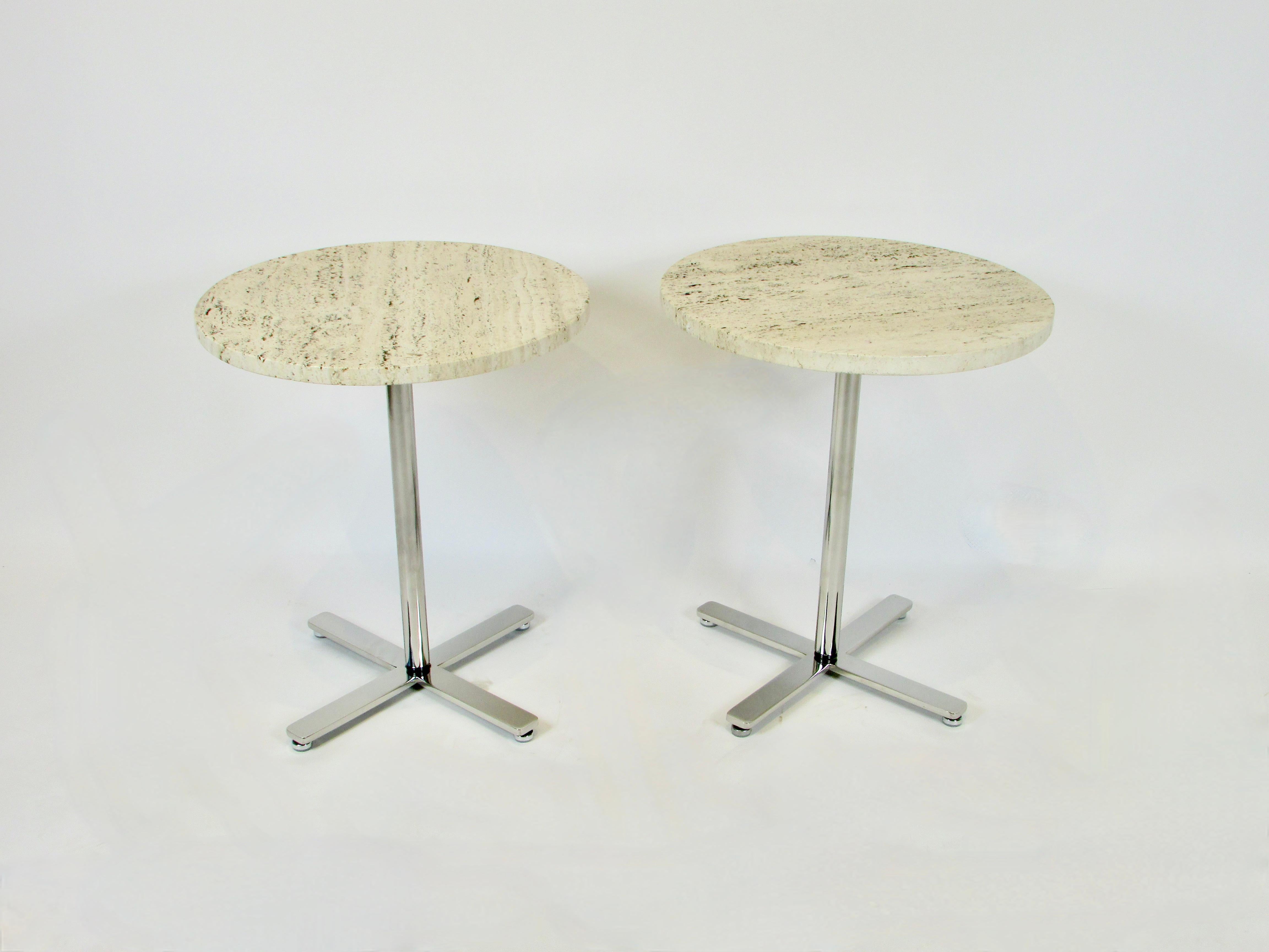 Pair of minimalist side tables manufactured by Helikon Furniture Circa 1970s before the Herman Miller Buy out. Beautiful open grained Travertine marble tops on stainless steel four prong base.