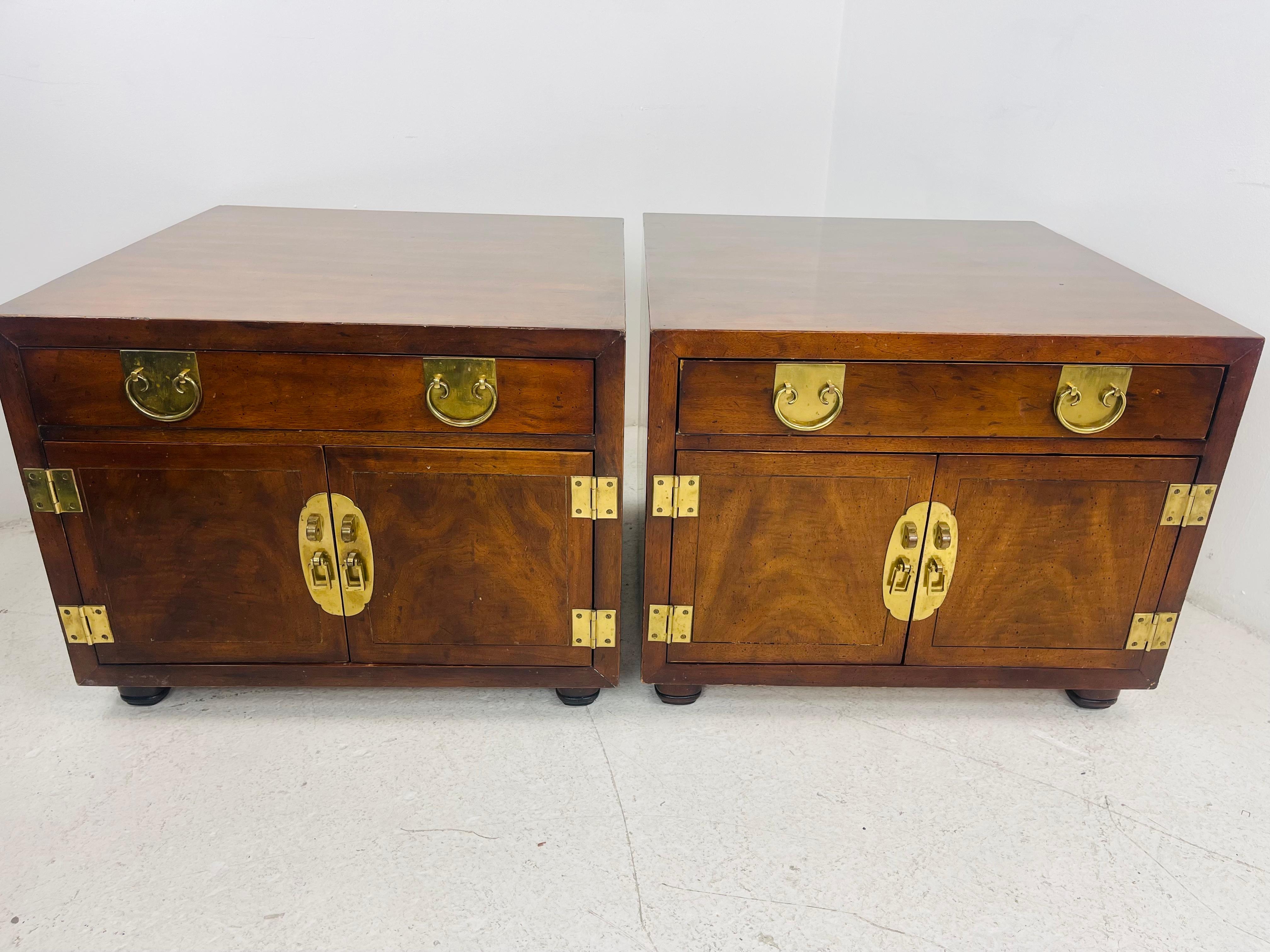 A fantastic pair of Henredon Chinoiserie campaign chests in good condition. Circa 1970s. Handsome solid brass hardware accents. Exceptional craftsmanship and detail. Some scratches and dings on front/edges due to age and use but tops are in great