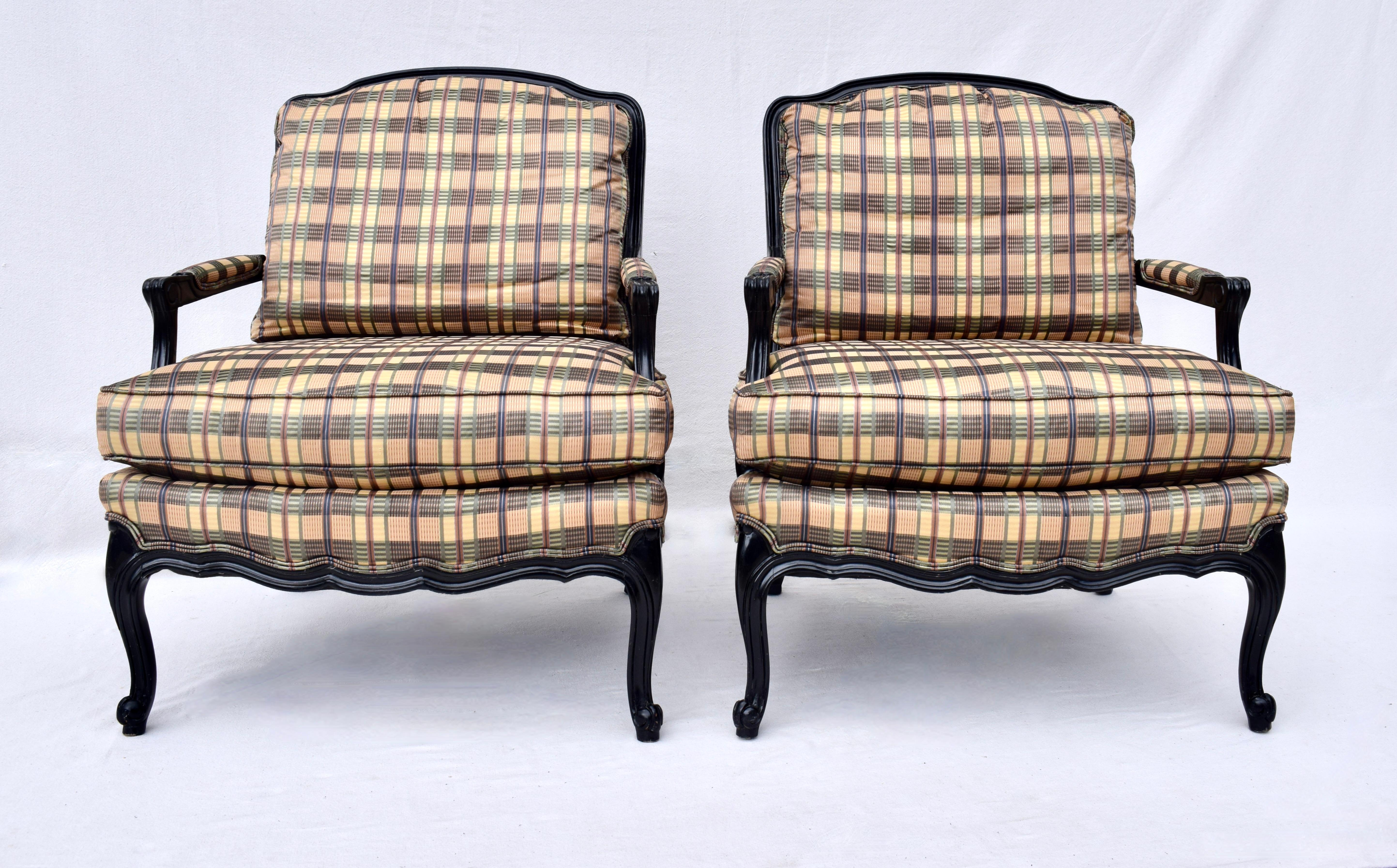 Pair of Henredon French Provincial style Bergere chairs of high-quality construction with black lacquer finish. Plaid upholstery with goose down cased cushions is in rarely used well cared for condition ready for use.. Seat 19