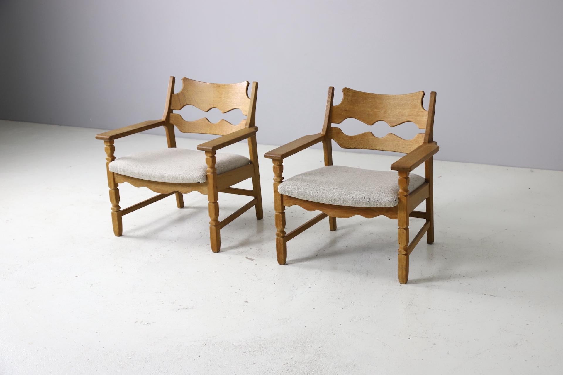 Original pair of 'Razor blade' lounge chairs by Henry Kjaernulf, 1911 - 1975. Produced by Nyrup Møbelfabrik, labeled underneath. The frames of the chairs are made out of sculpturally shaped oak with a nice and warm patina. The seats have been