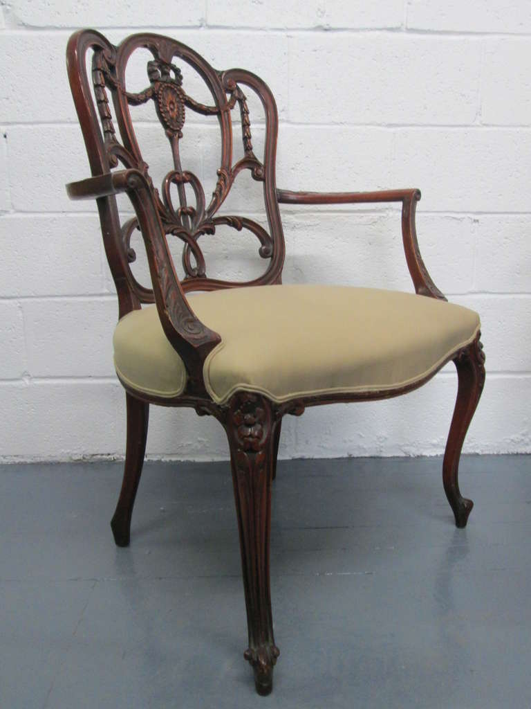 Pair of Hepplewhite style armchairs. The chairs have a mahogany frame and newly upholstered seats.
 