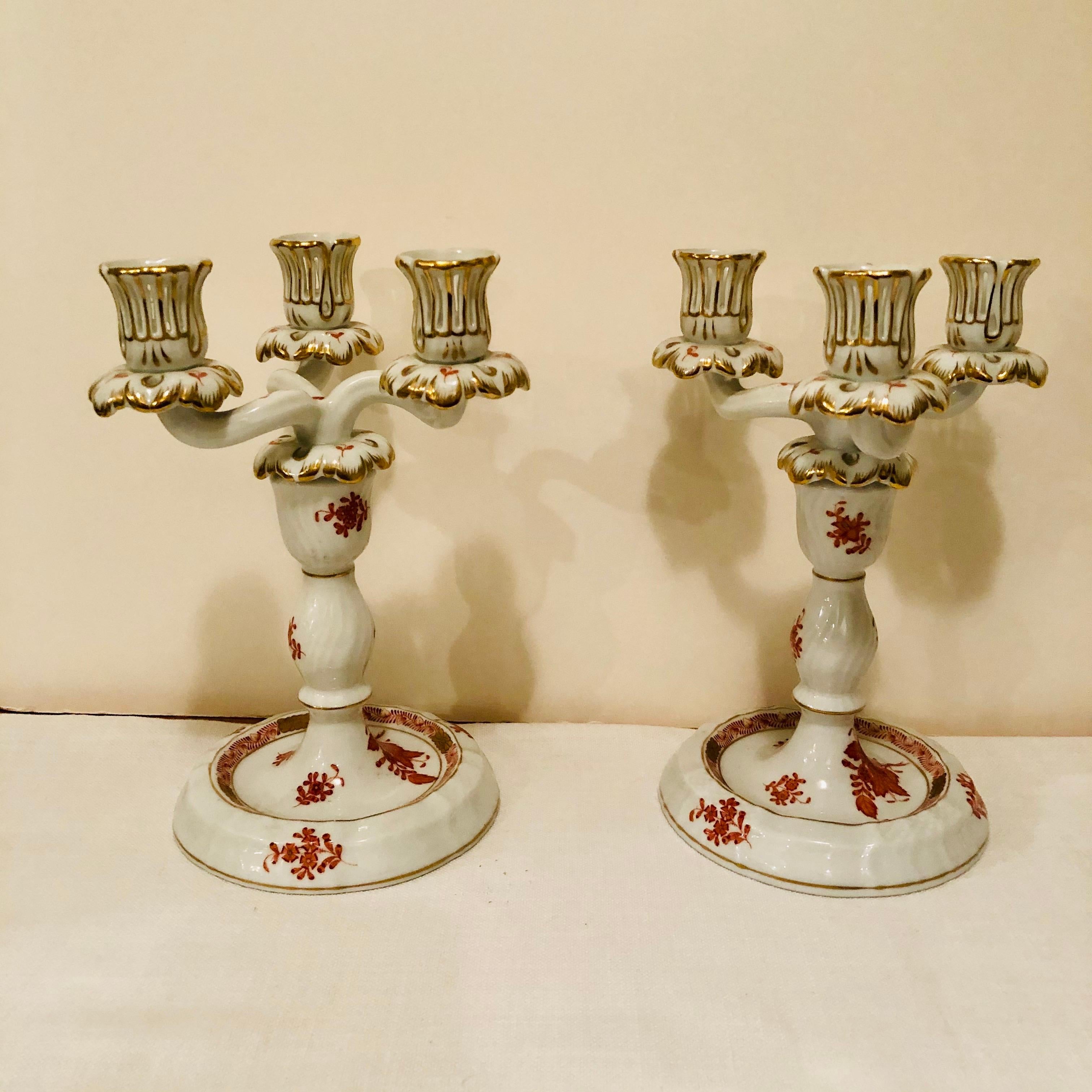 I want to offer you this stunning pair of Herend Chinese Bouquet candelabras in the rust/ apponyi orange design. Each of the candelabra has 3 arms to hold three candlesticks. Each candelabra is two pieces. If you take the top piece off, you can use