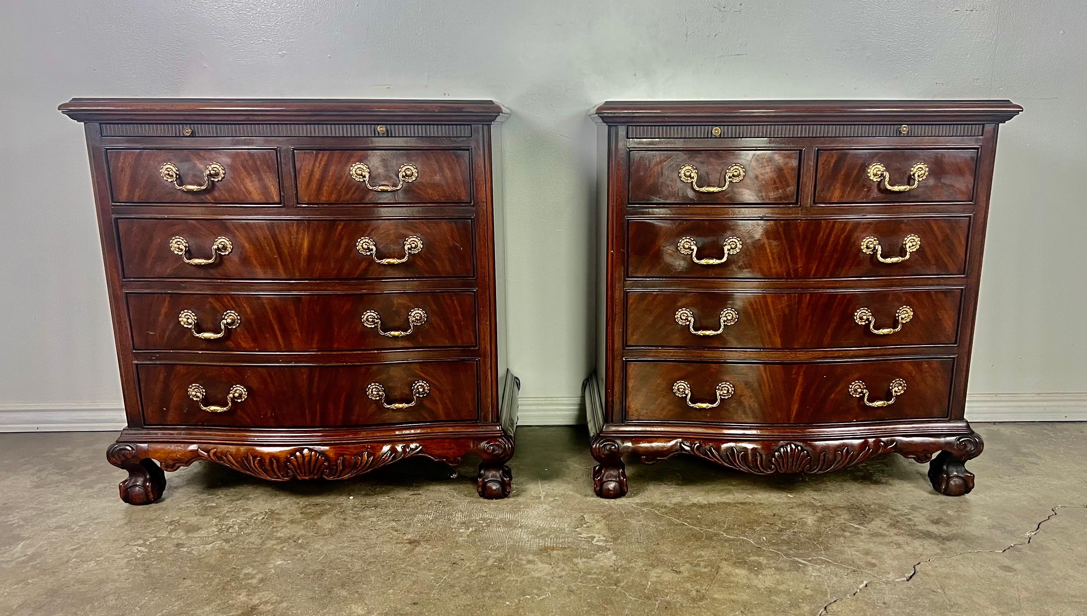 Drexel Heritage Cambridge flamed mahogany wood five drawer dresser chests.  Pullout on top of the drawers with brass knobs.  Quality American craftsmanship. Circa mid 20th Century.  The chests are detailed with a shell design at the base and stand