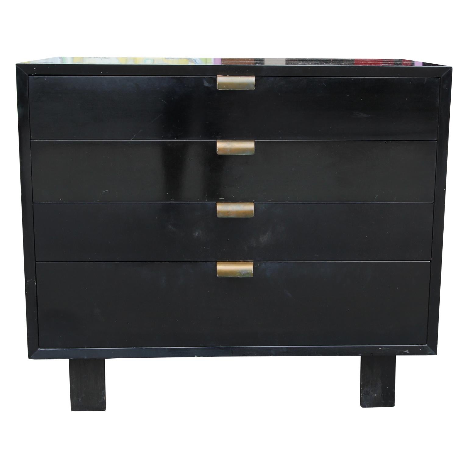 Pair of 1950s Herman Miller black finished dressers designed by George Nelson. Each drawer has brass color handles and the bottom drawer has wooden dividers. The dressers are sold as is. Consult condition report for details.