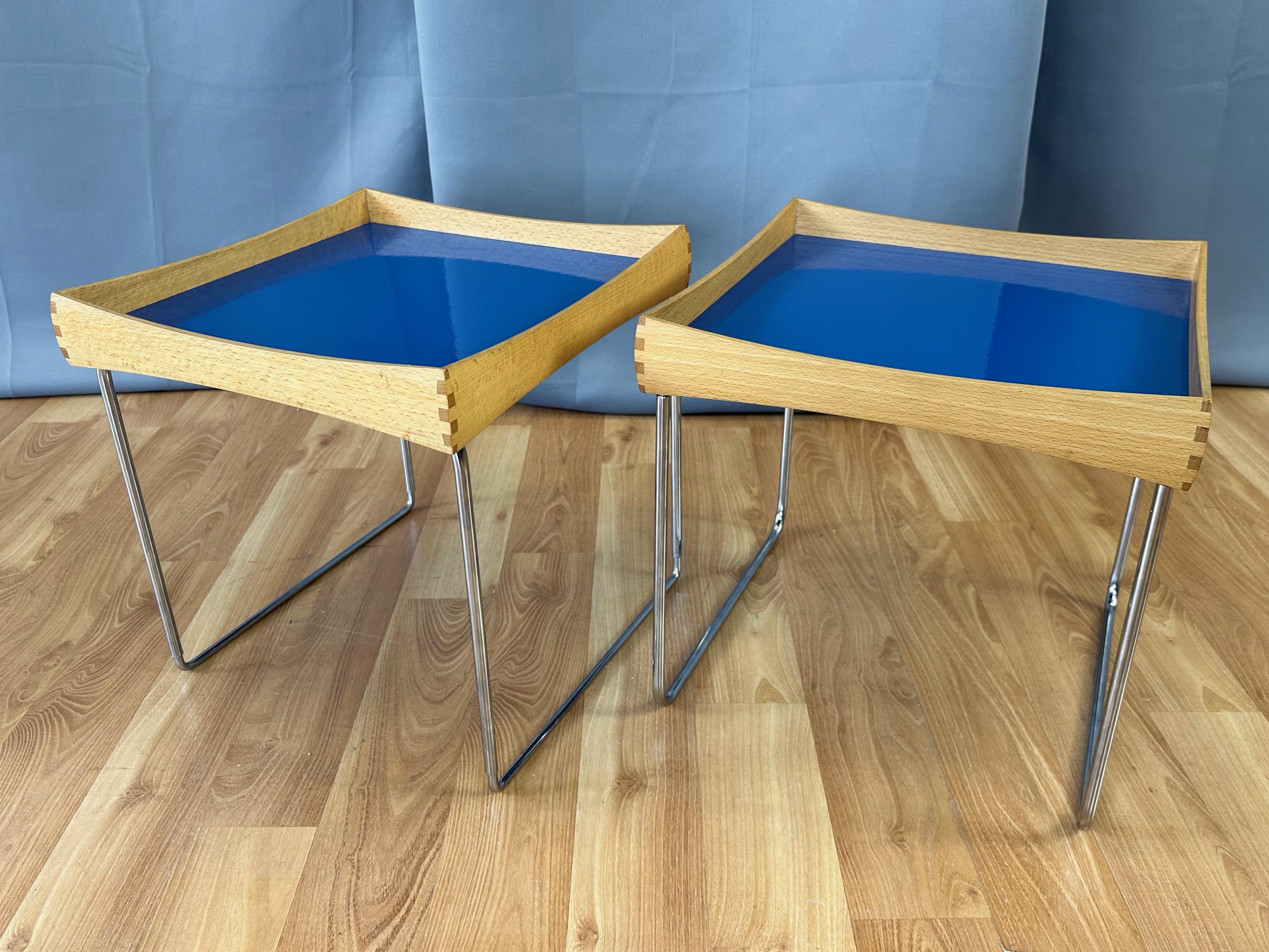 A delightful pair of 1961 Norwegian Conform tray tables by Hermann Bongard for Plus in very rare beech with solid blue Catherineholm enameled steel tops.

Designed in 1961 by notable Norwegian industrial and graphic designer, glass artist, and