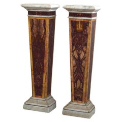 Pair of herms in red marble