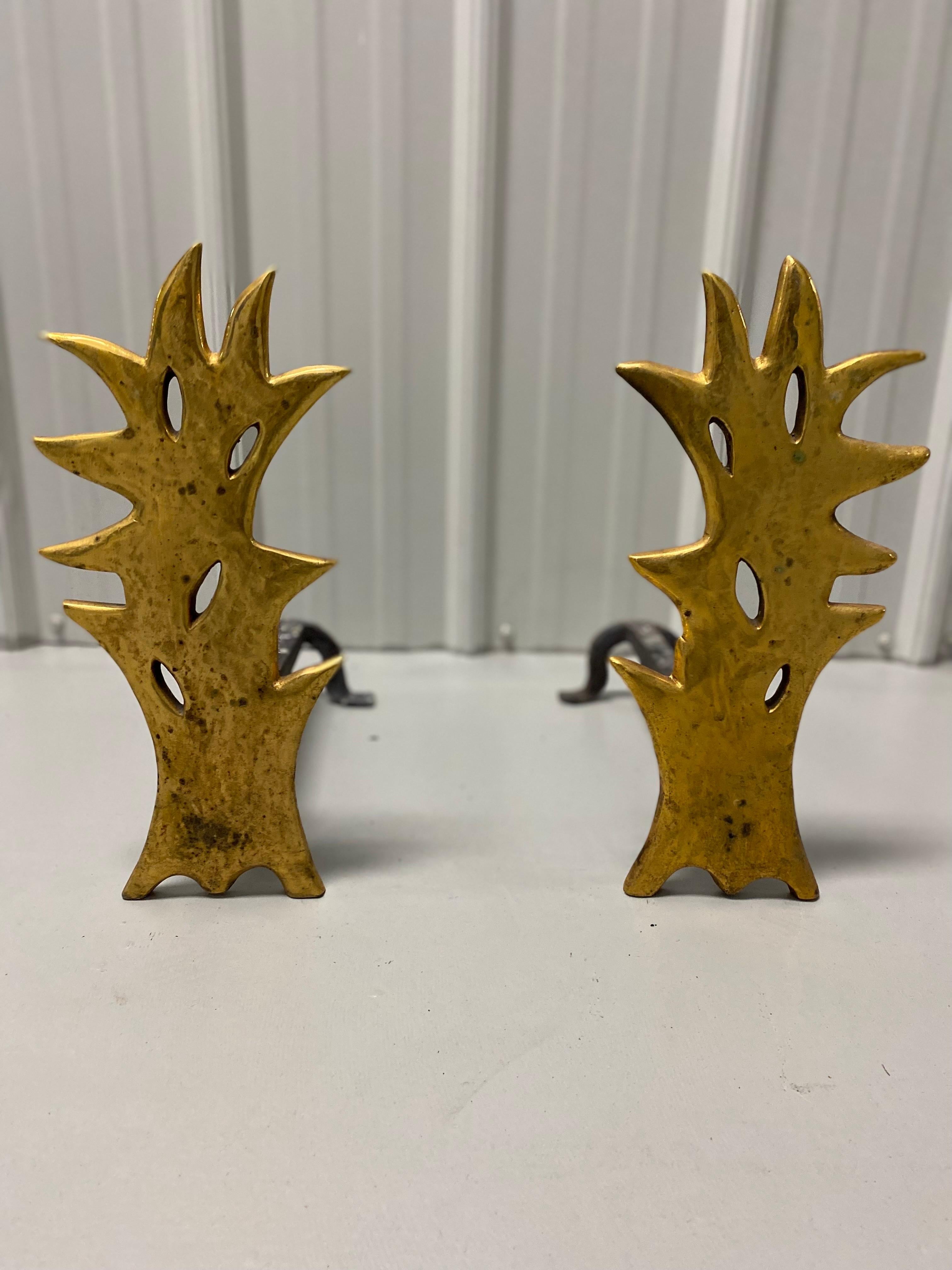 Pair of Herve Van Der Straeten Flame Gilt Bronze Andirons.
Chic pair of flame sculpted andirons made of gilt bronze. Irons fit into backs of bronze flames. Four pieces. Blackening from general use on backside.  Otherwise good condition with general