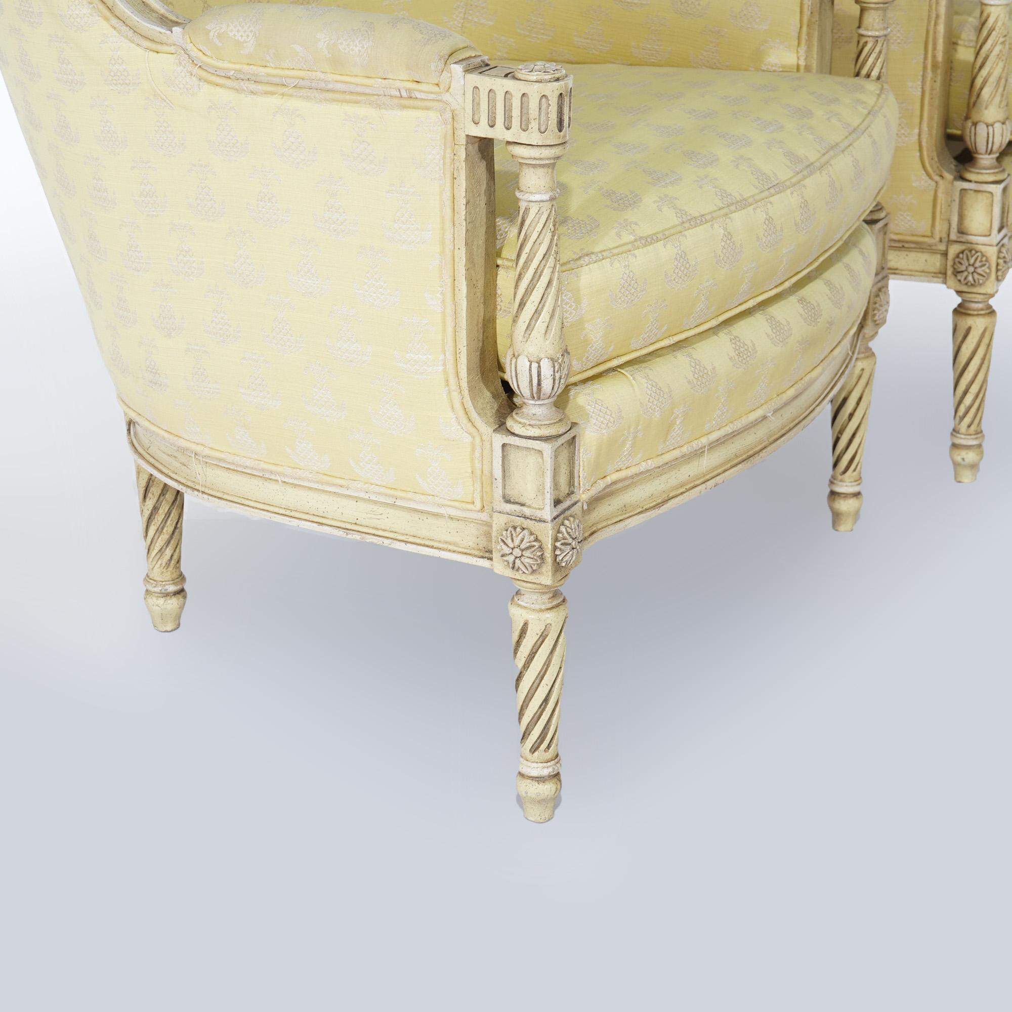A pair of French Louis XVI style bergere chairs by Hibriten-Bernhardt offer curved form with upholstered throughout, carved rope twist arms and raised on turned and tapered legs with rosette capitals, 20thC

Measures- 33.5''H x 26.5''W x