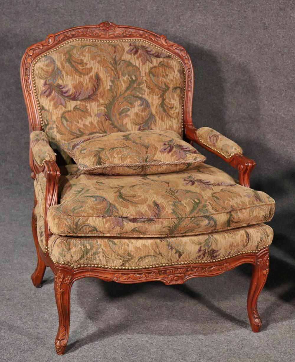Pair of Hickory White Louis XV style carved walnut oversized lounge chairs with tapestry upholstery, nailhead trim, and matching accent pillows.