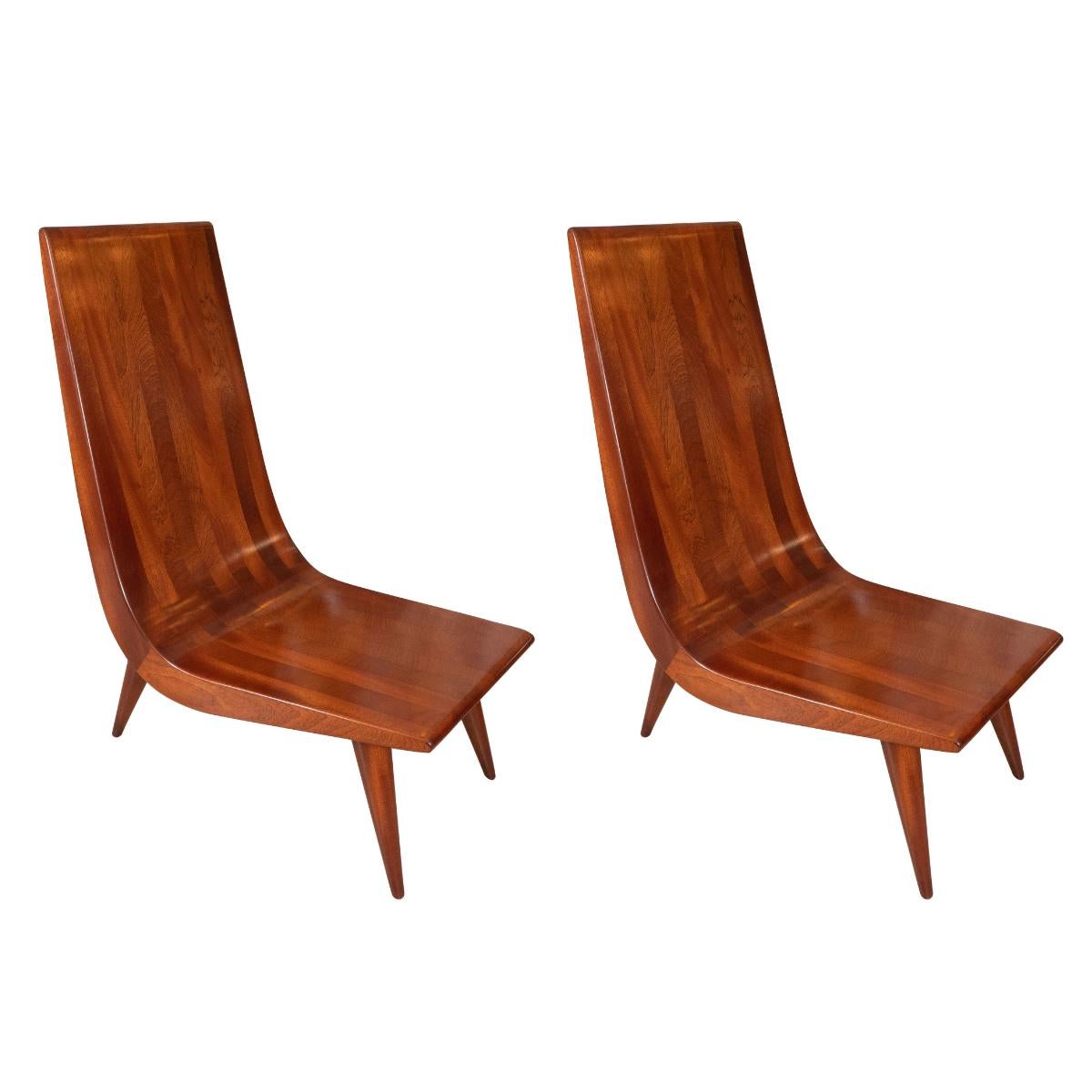 Pair of high back, curvilinear African mahogany slipper chairs by Carlos Da COSTA.