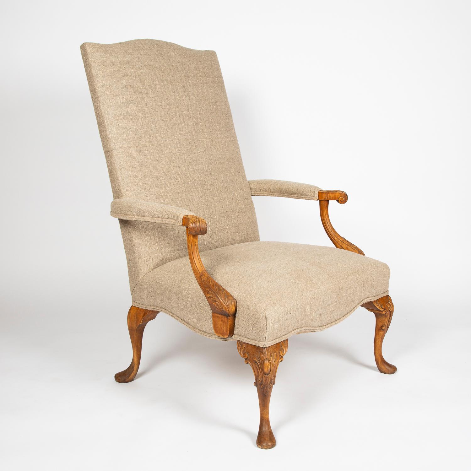 A pair of carved beech high back armchairs with detailed carved arms, cabriole legs and pad feet, upholstered in linen. 

 