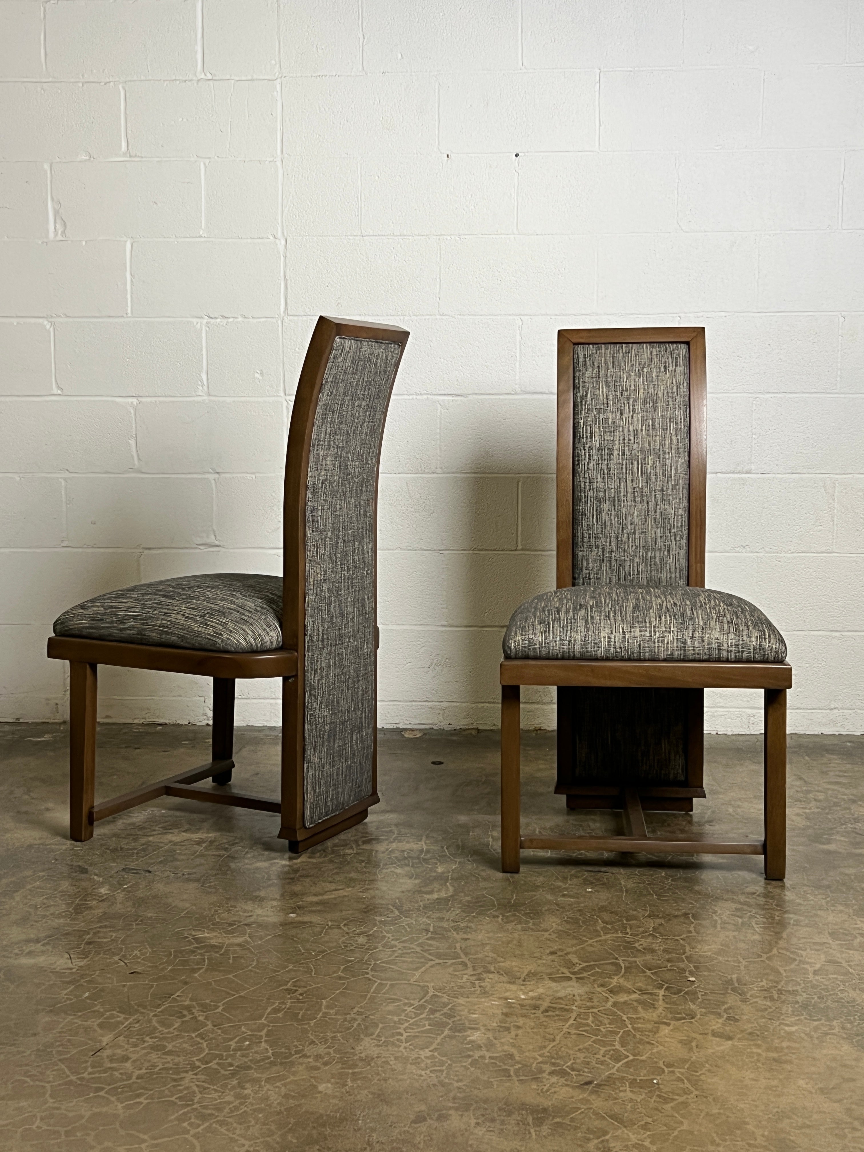 A pair of high back mahogany chairs by Frank Lloyd Wright for Henredon.