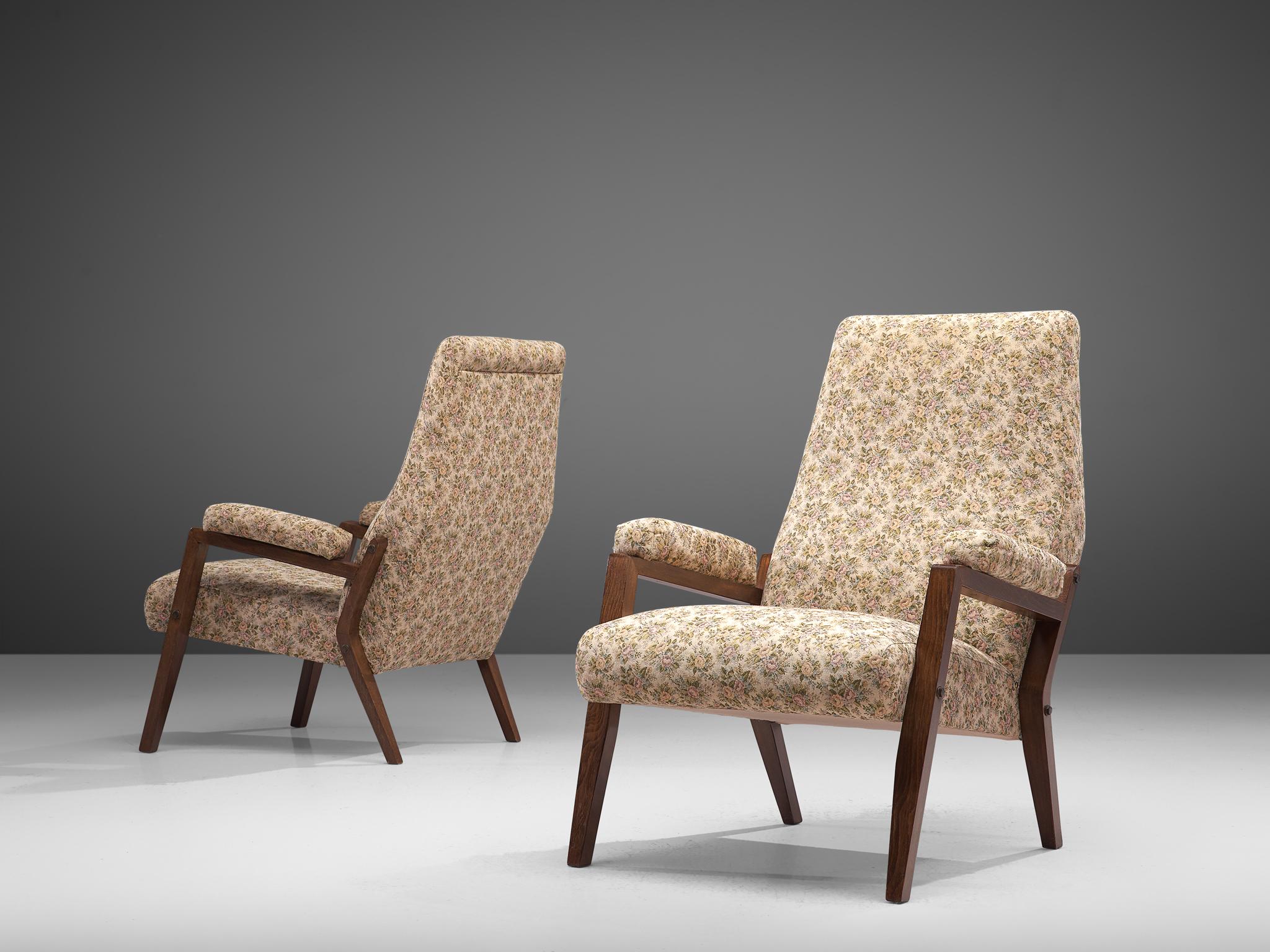 Italian lounge chairs, floral fabric, stained beech, Italy, circa 1950.

This set of two elegant armchairs in wood and light colored, floral fabric upholstery. The high tapered wooden legs provide an open look to the L-shaped seating. Beautiful