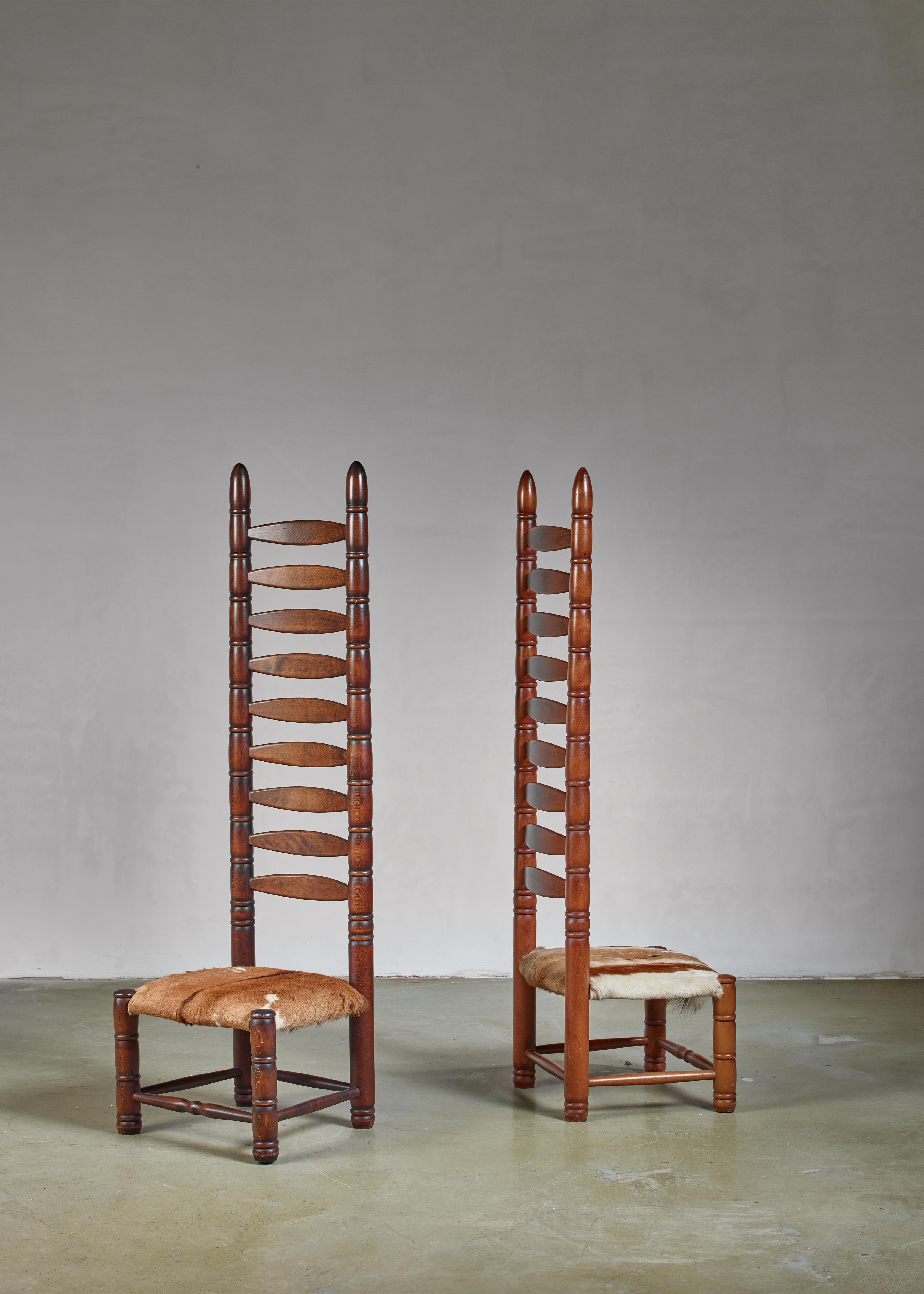 A pair of decorative Bohemian object chairs from the 1960s. This matching pair of high back ladder chairs is upholstered with goatskin.