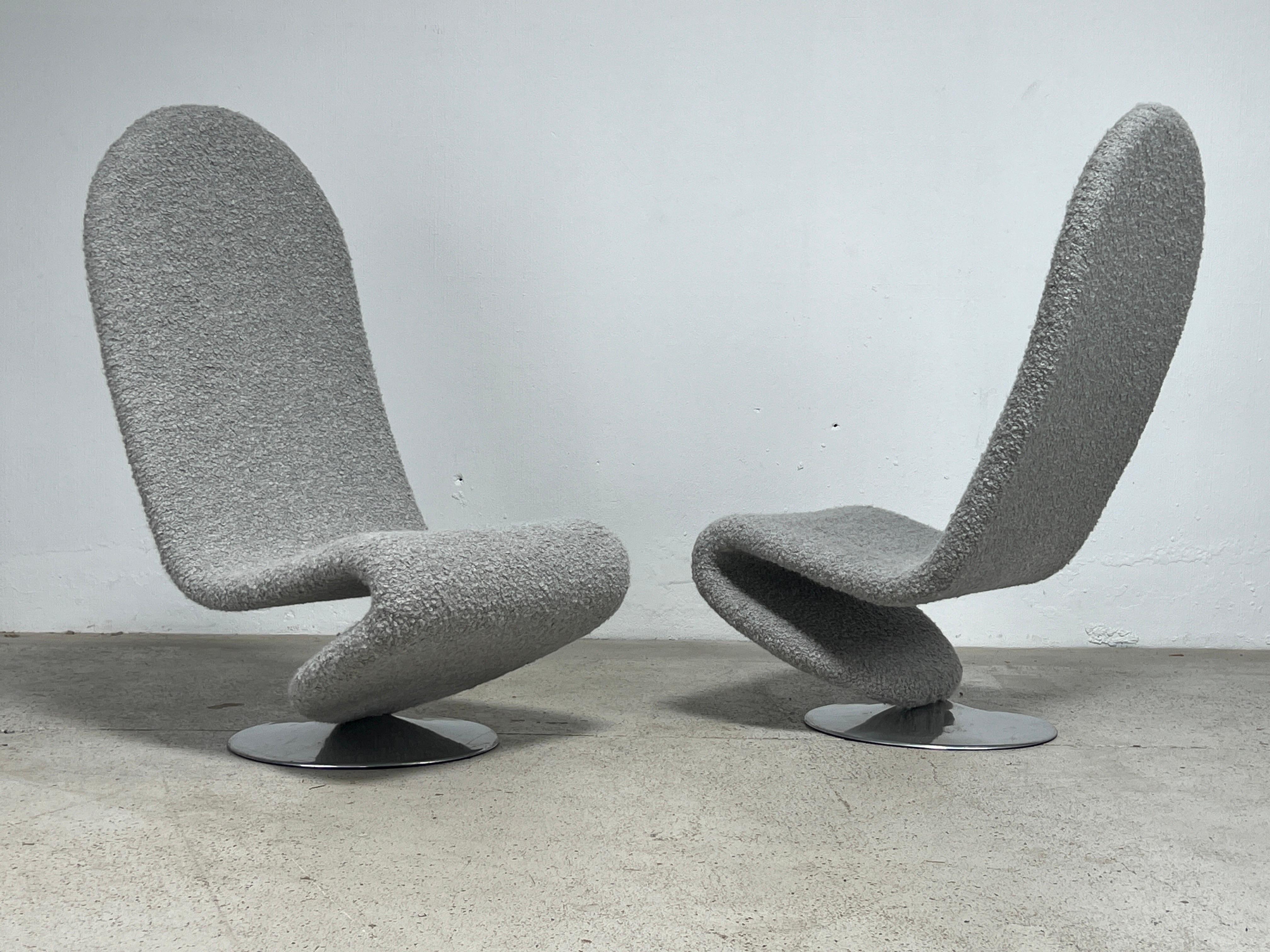 A pair of high back 1-2-3 swiveling lounge chairs designed by Verner Panton for Fritz Hansen reupholstered in Holly Hunt / Teddy / Warm Silver. 