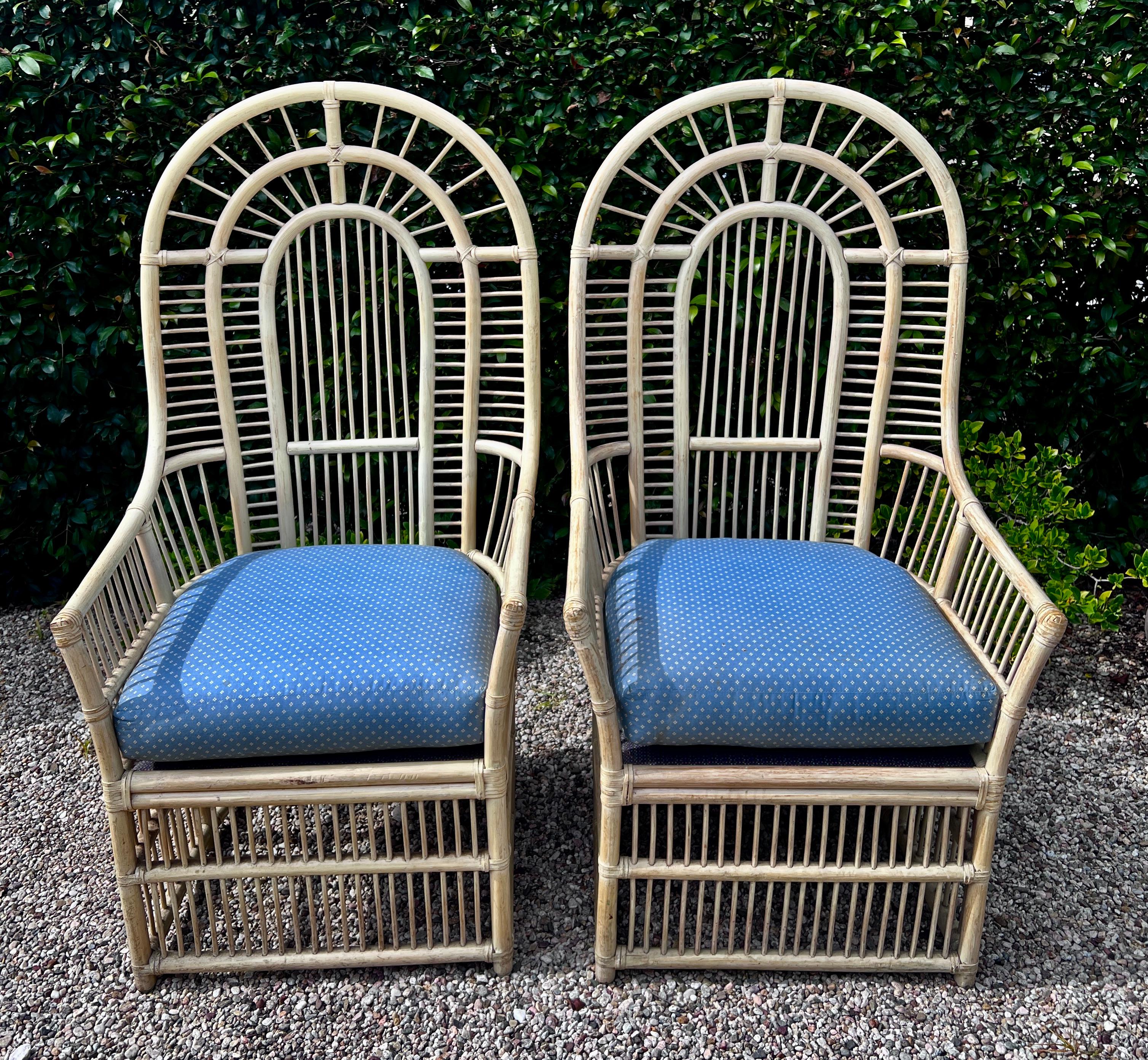 A stunning Pair of High Back Rattan Chairs with a rounded top and intricate detailed rattan work.  The pair are very sturdy and comfortable.  They are large and roomy, making them comfortable and a statement.

The pair were a custom made chair for a