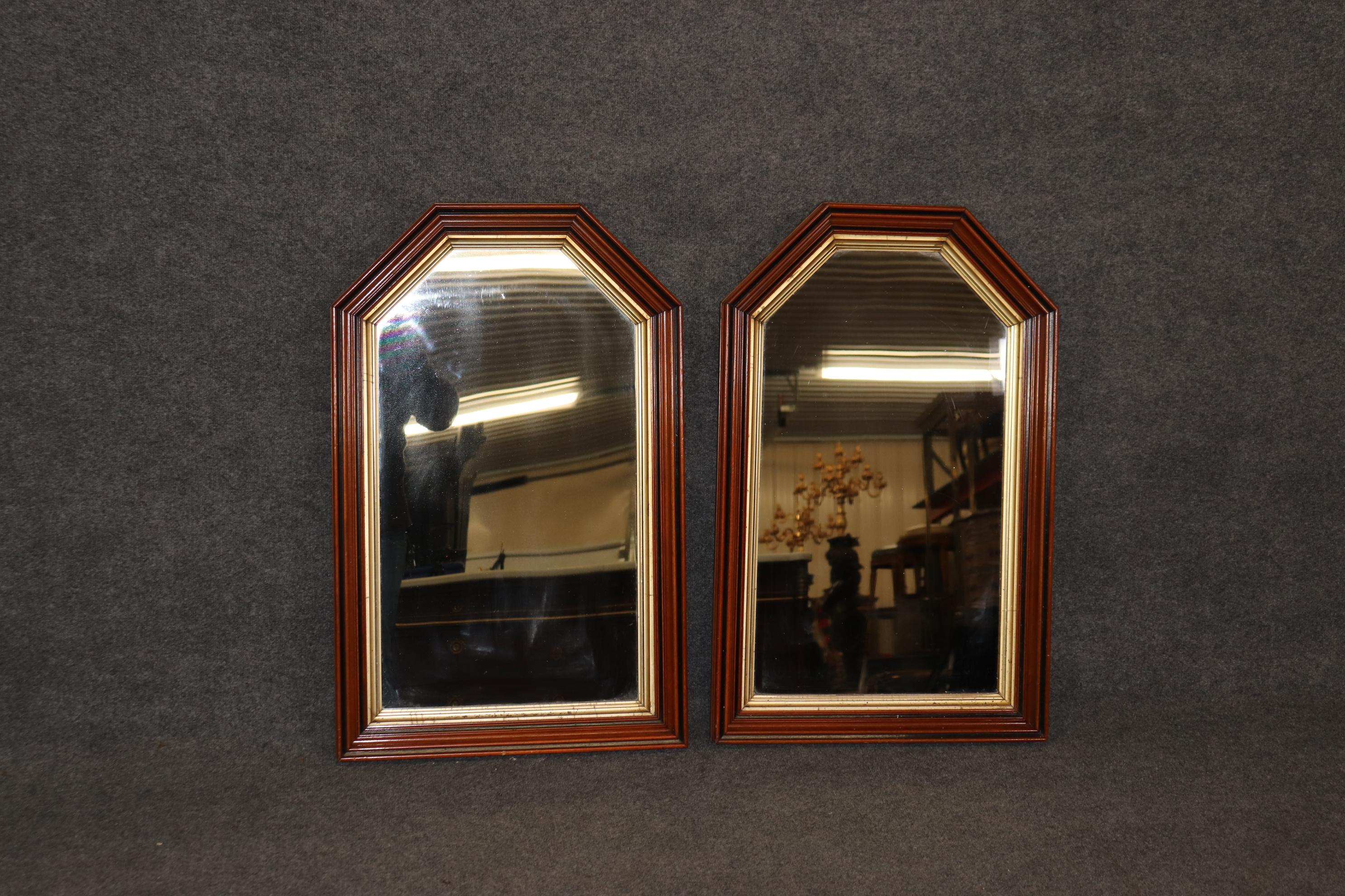 This is a unique pair of beautiful solid walnut geometric mirrors that evoque a Gothic feeling. The interior of the molding is done in bright gold leaf and in good condition. The mirrors date to the 1880s era and are European and measure 35.5 tall x