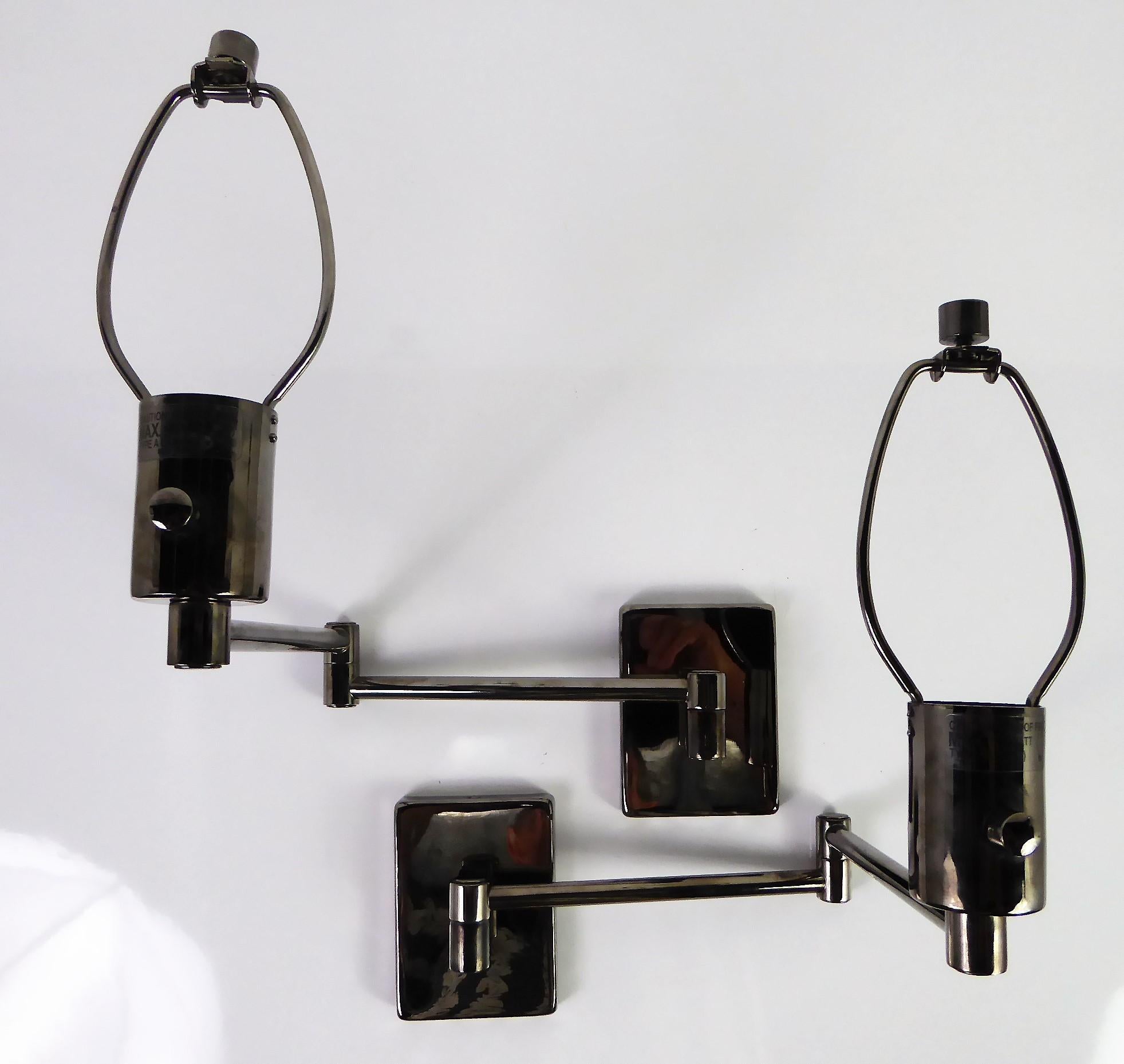 Elegant pair of classic George Hansen designed swing arm wall lights in bright gunmetal finish with a dimmer switch. Made by MetalArte in Spain for Hinson Lamps, now a subsidiary of Donghia. This pair of wall lamps come with their original Black