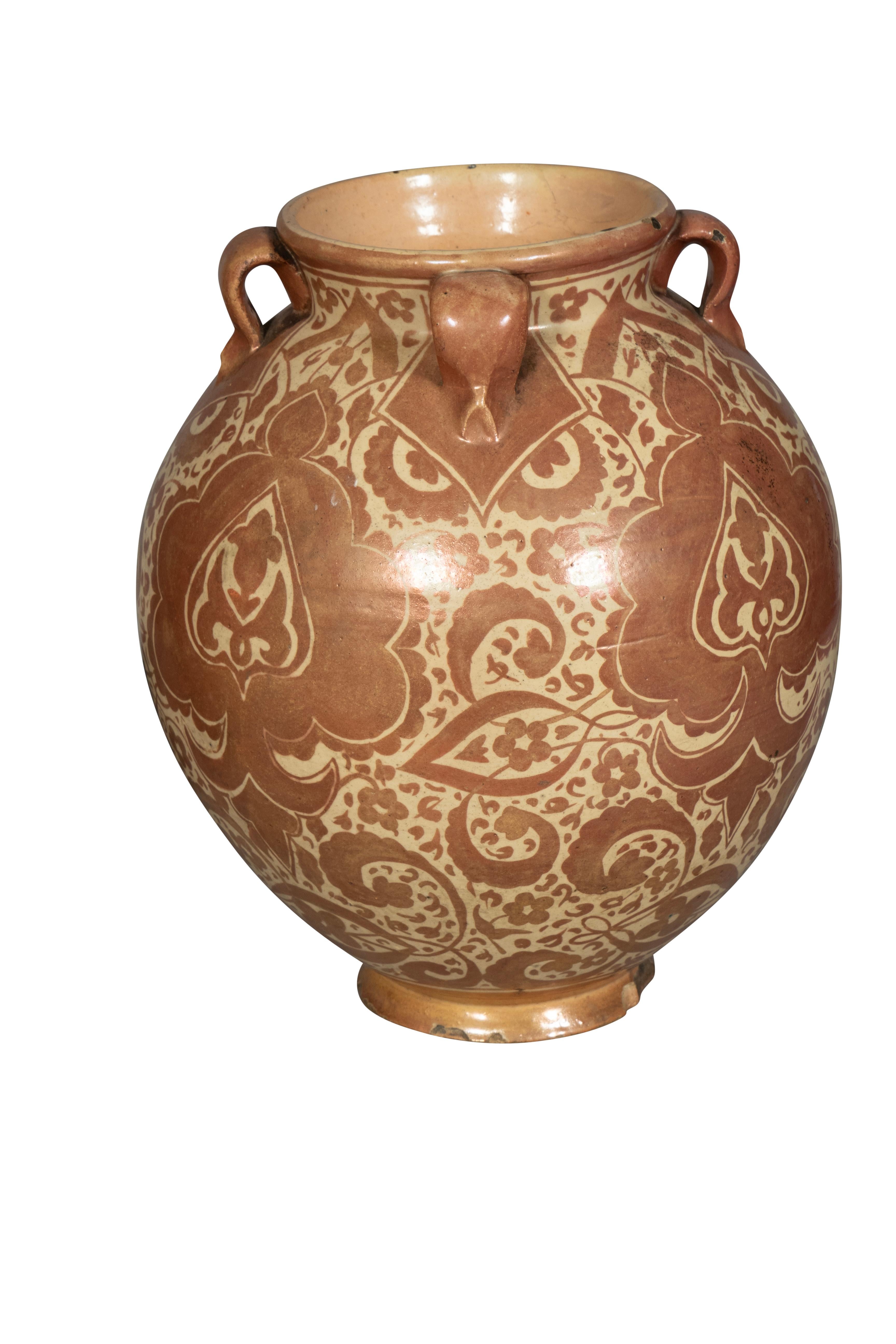 Likely Portugese heavily potted with copper and cream tones. Globular form with small loop ring handles and Alhambresque palette decoration. Conforming raised foot.