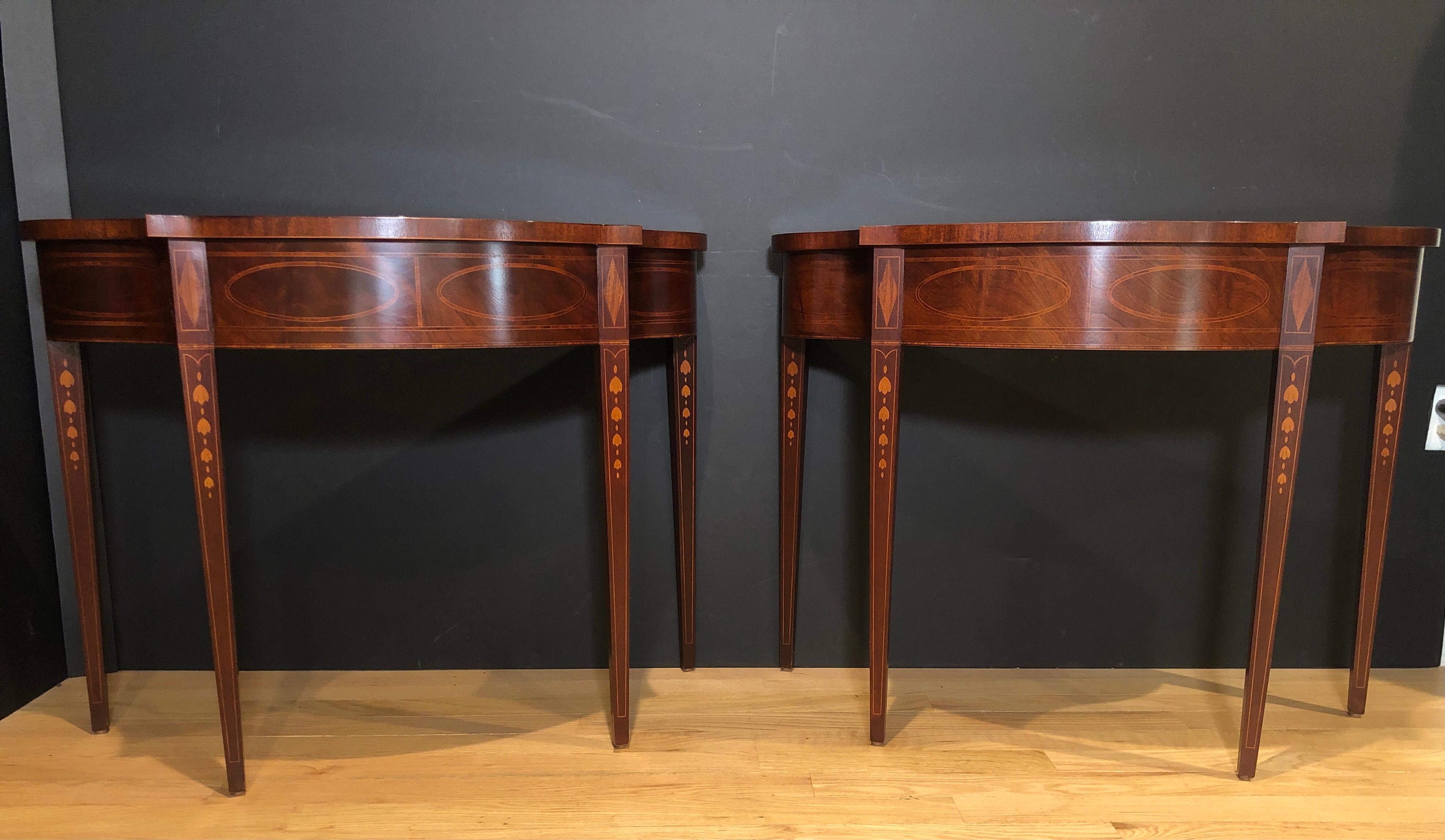 Pair of historic Charleston demilune console tables by Baker. Beautiful serpentine sides. Inlaid on sides and legs.