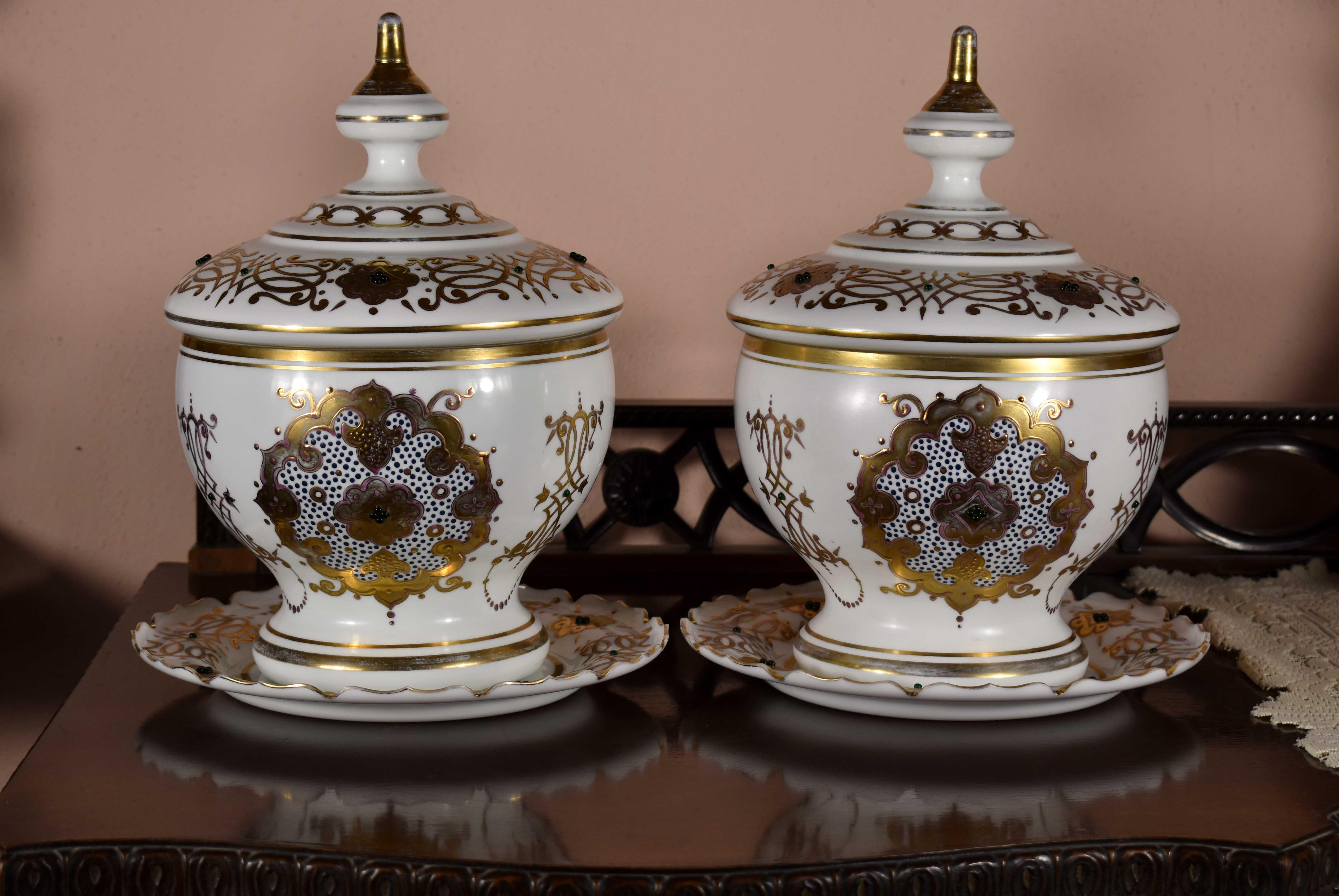 A pair of historic glass bomboniers made of opal glass decorated with embossed gilded painting and glass beads. Bohemian glass made for the Ottoman market.