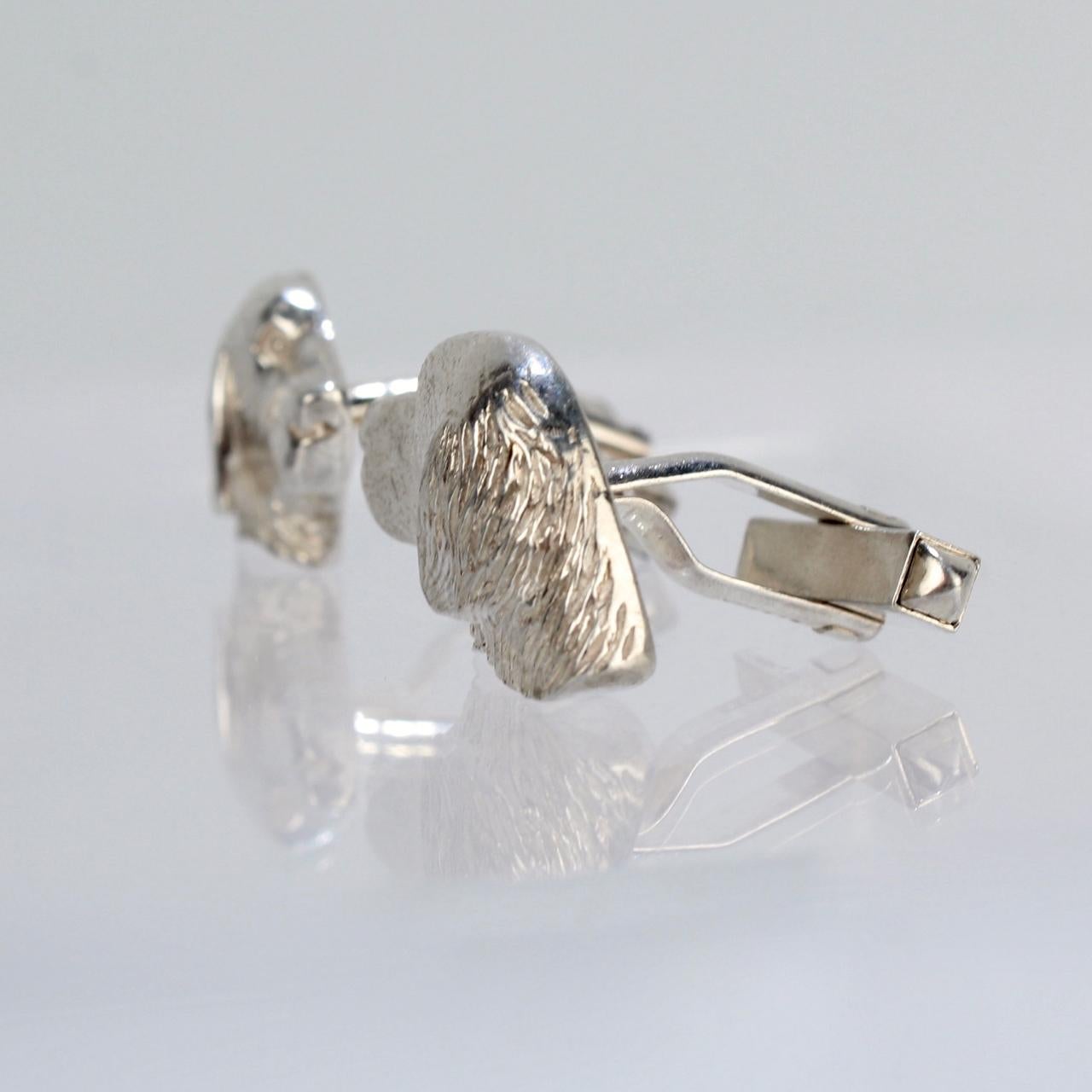 A fine pair of sterling silver hunt-related cufflinks in the form of a Golden Retrievers in profile.

Marked for Holland & Holland -  the storied London Gunmakers and & Sportsman company.

Simply the perfect accessory for the Sportsman or Golden
