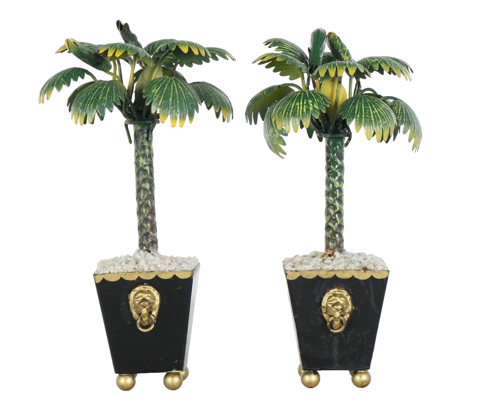 Bring a bold dose of Palm Beach glamour to your space with this striking pair of Italian Hollywood Regency tole palm tree topiaries. Sculptural and dramatic, each tree features lushly layered fronds crafted from hand-painted tole in a rich,