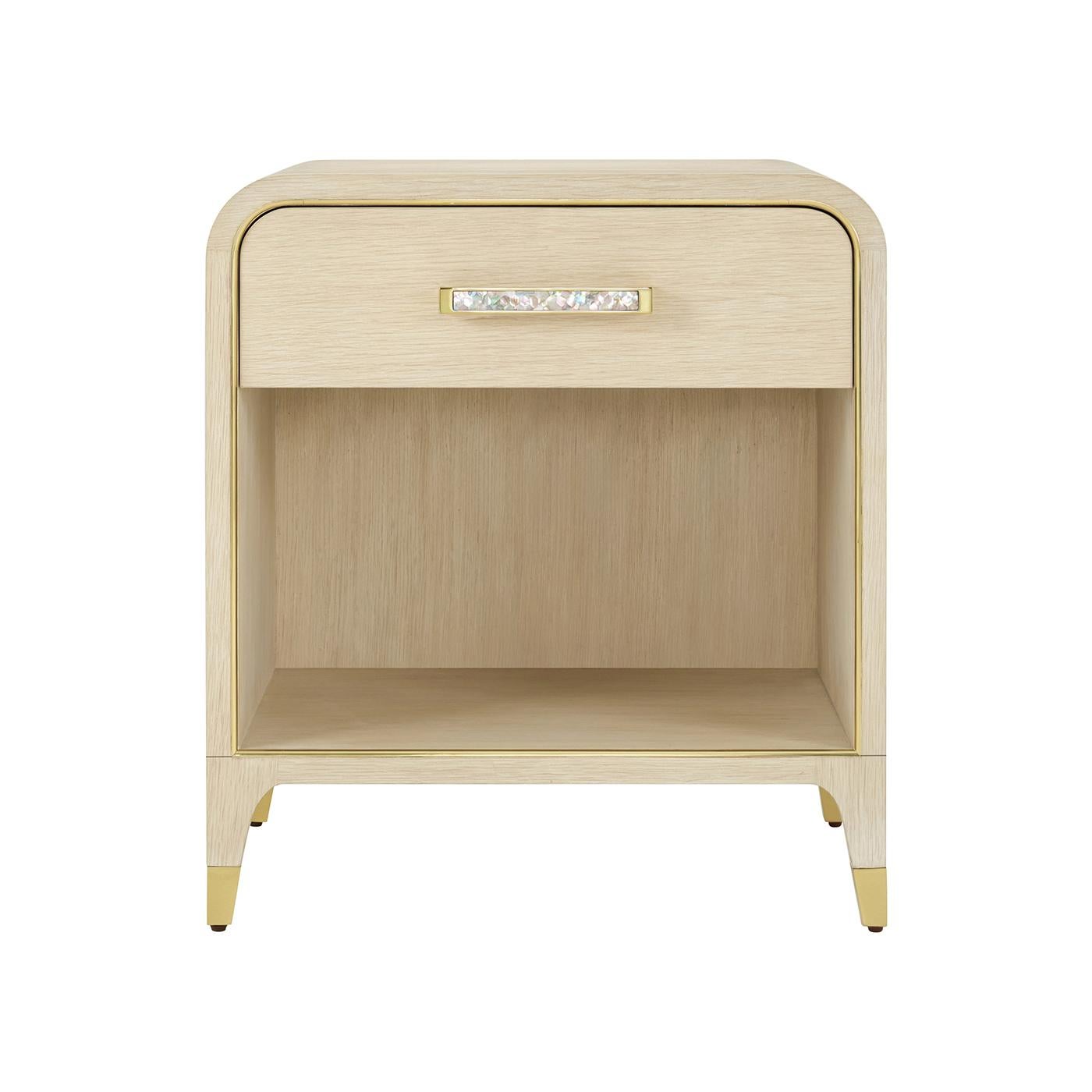 Meticulously artisan made and finished in a light wood martini finish, it pairs effortlessly with the matching dresser or bed as a luxurious statement piece for those who embrace an elegant approach to life.

A large drawer offers convenient