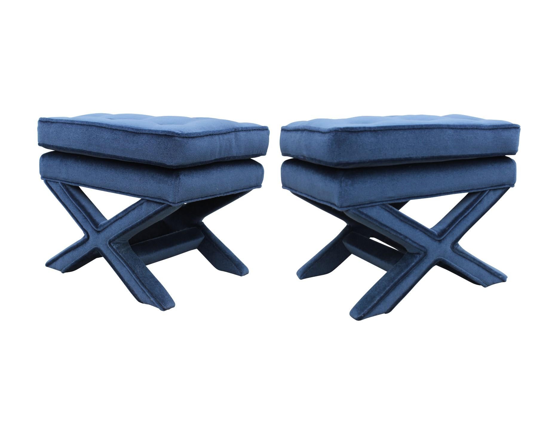 Luxurious Pair of Hollywood Regency x-base stools or ottomans by Milo Baughman. They are covered in a tufted blue mohair.