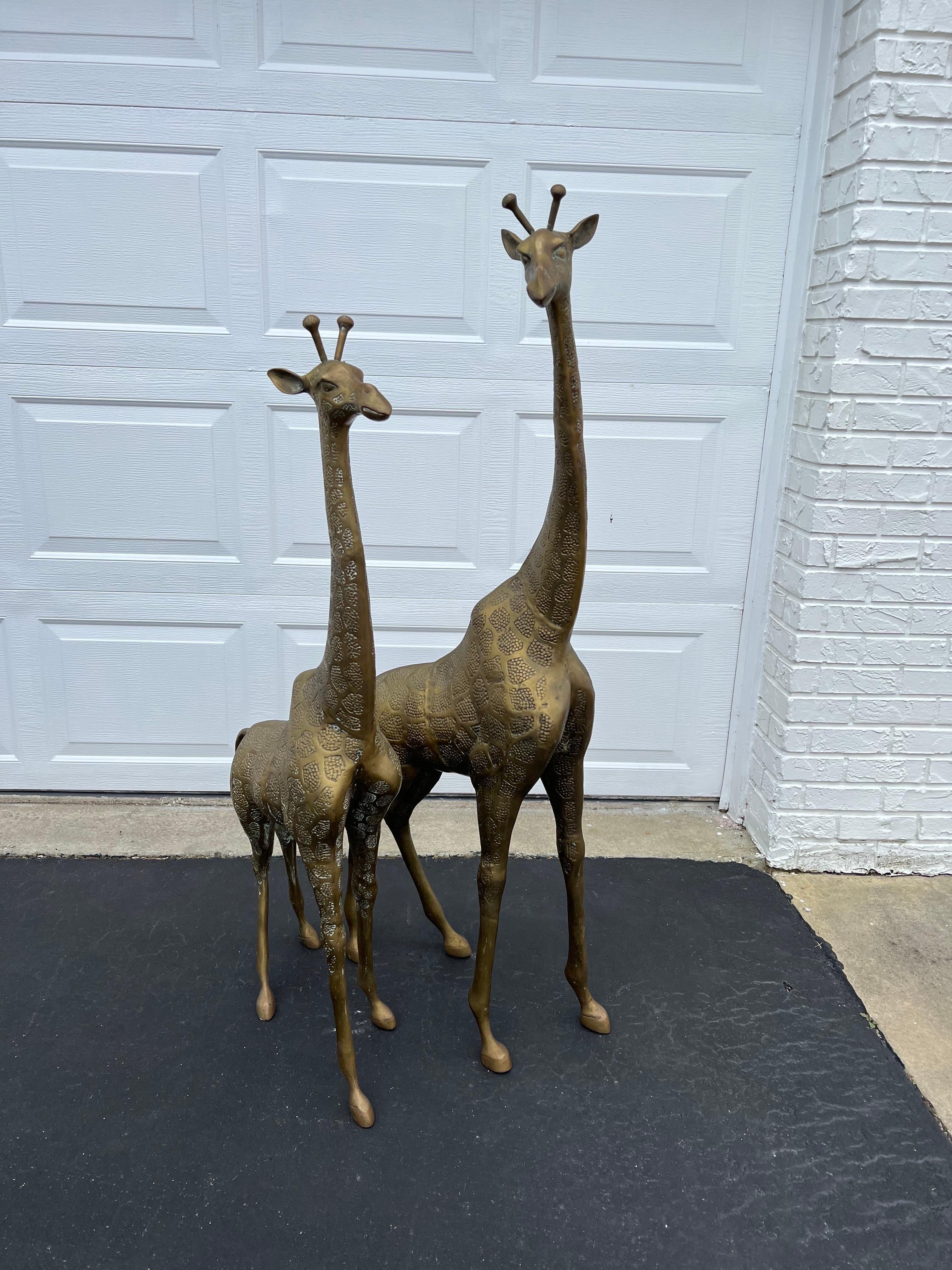 Pair of Hollywood Regency brass giraffes -mother and child. Amazing pair of vintage decorative sculptures, sweet mother and child set. Great for a design statement. Circa 1980-1989 , Possibly by Dolbi Cashier. Dimensions are for larger giraffe.
