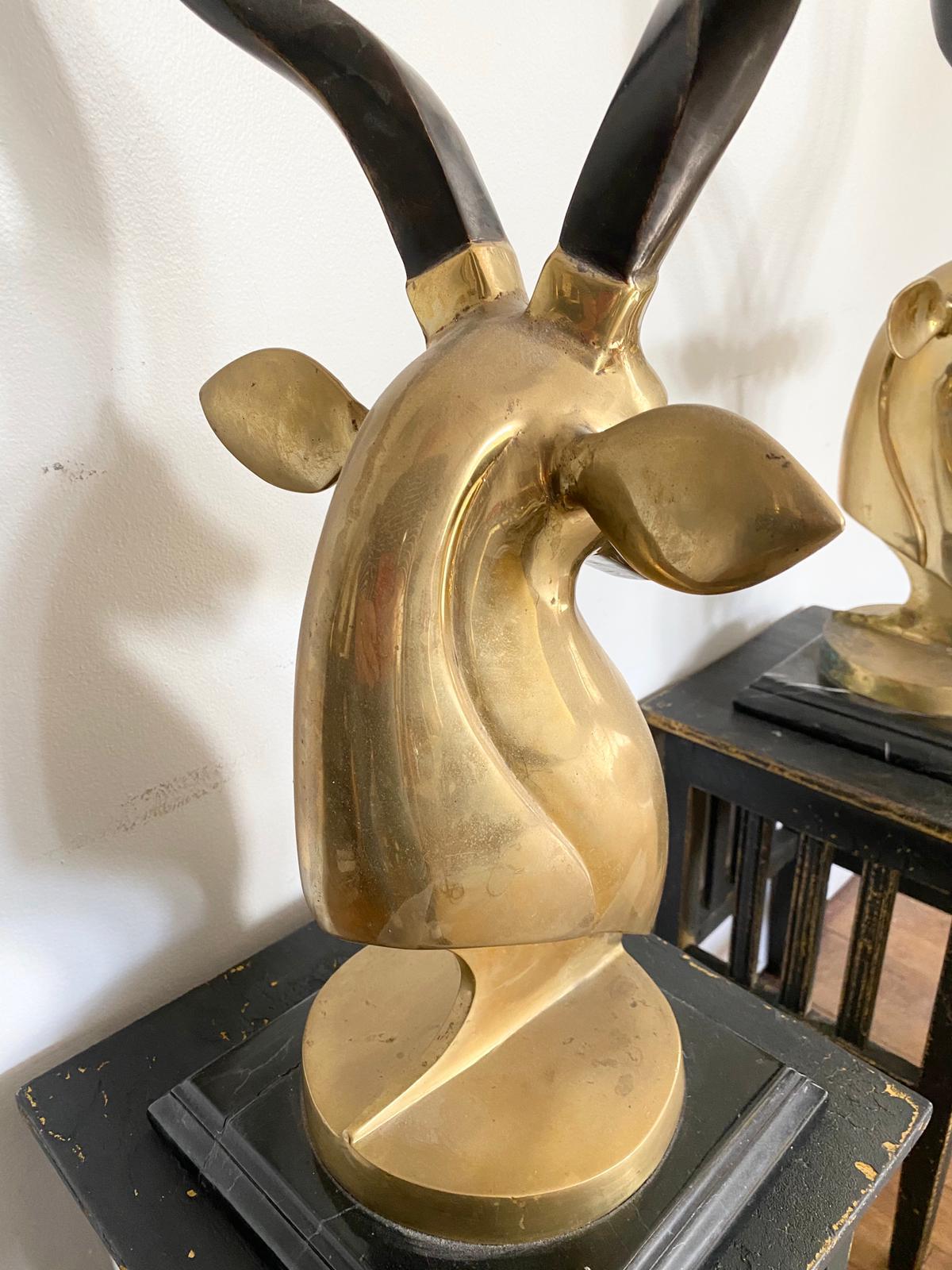 A fine pair of Kudu, antelope head sculptures, made in brass on a marble base, these make a stunning impact in a room.
A true Hollywood Regency pair of sculptures with dominating impact.
  