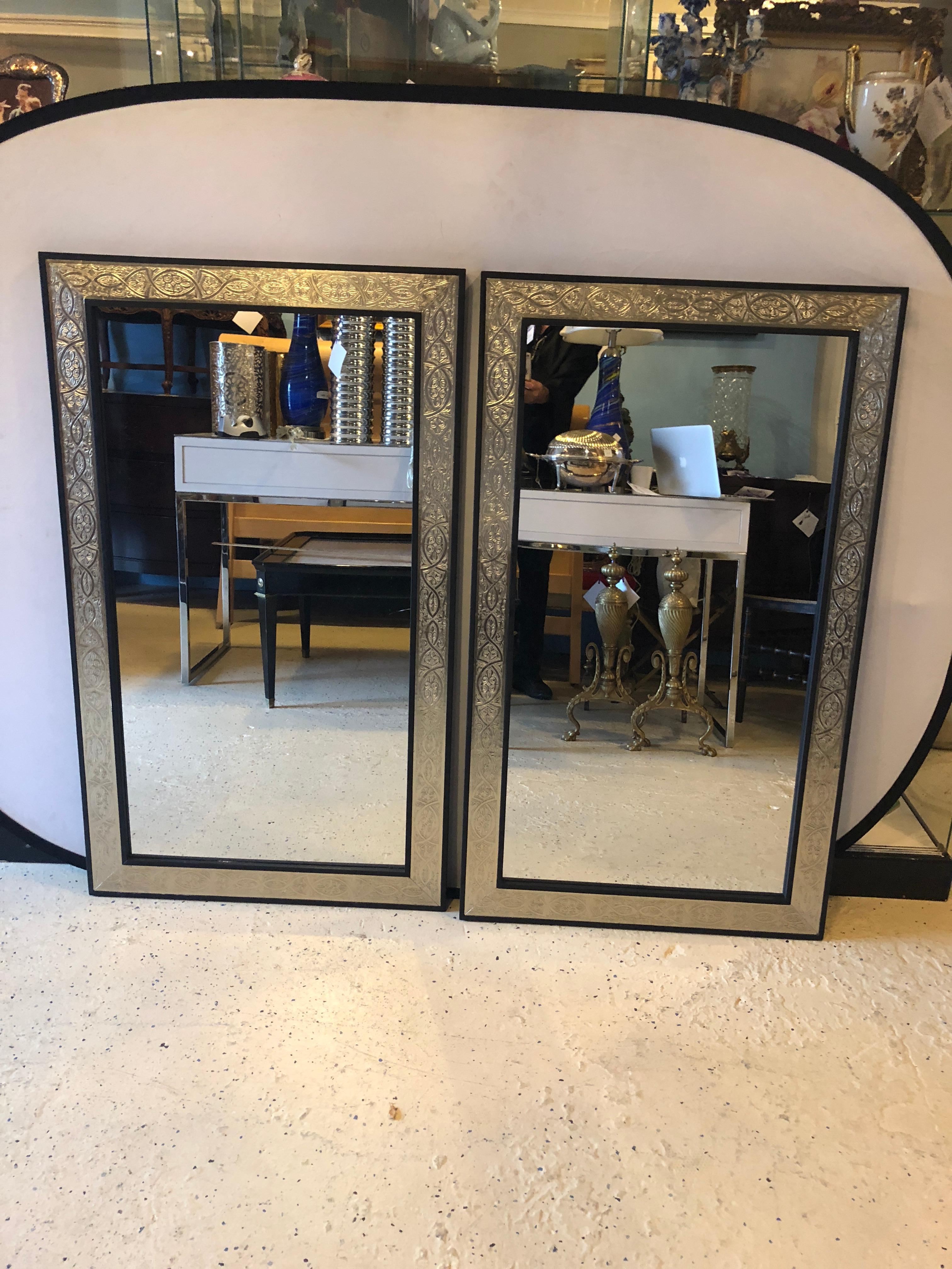 Pair of Hollywood Regency brass over wood Moroccan Ebony framed hand hammered wall or console mirrors. These fine large and impressive wall mirrors are sure to make your home gleam with style and fashion.