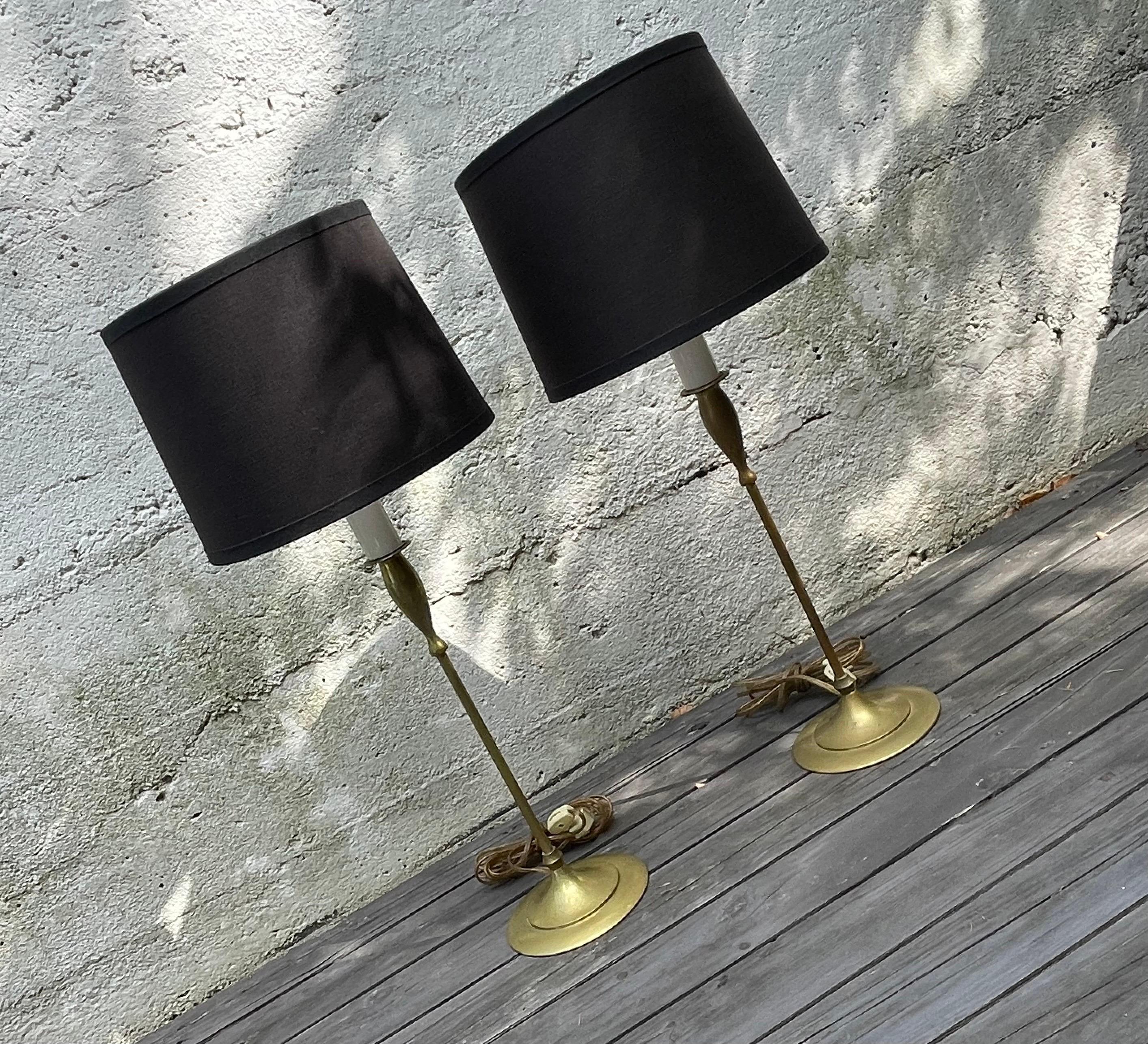 Sexy pair of Hollywood Regency brass tulip base table lamps by Charles Parker Co.  

19 inches to top of socket, 25 inches to top of harp, shades by RH slightly tapered and 7.75 inches in diameter, not included in the sale.