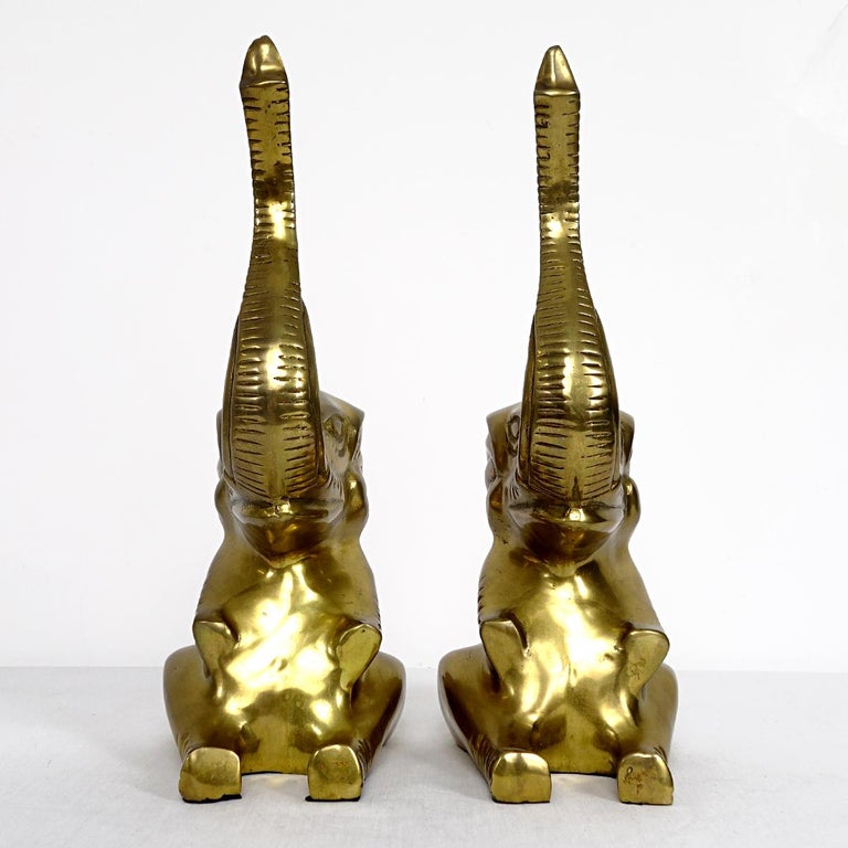 Lovely pair of brass elephants in Hollywood Regency style.
The sitting animals have their trunks high up in the air, giving the figurines a very cheerful radiation.
If you are interested in feng shui, the ancient Chinese knowledge of placement,