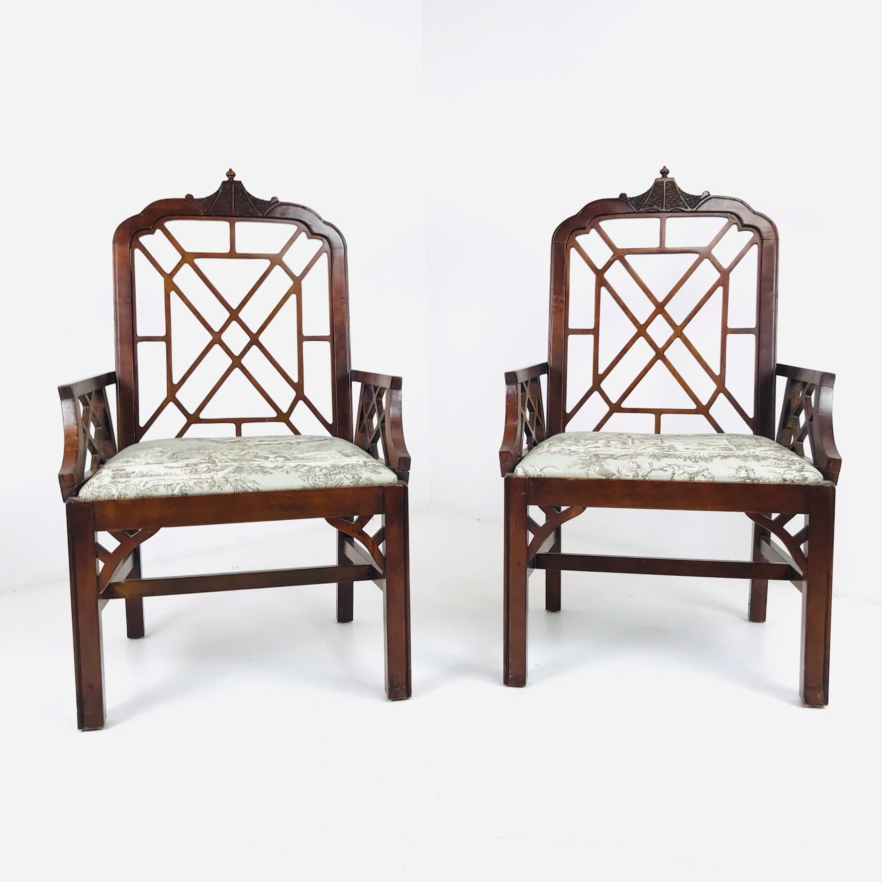 Pair of Chinese Chippendale style mahogany armchairs with upholstered seats. Features striking fretwork details with carved pagoda style back finial and carved brackets at the front and sides.
Chairs measure: 18