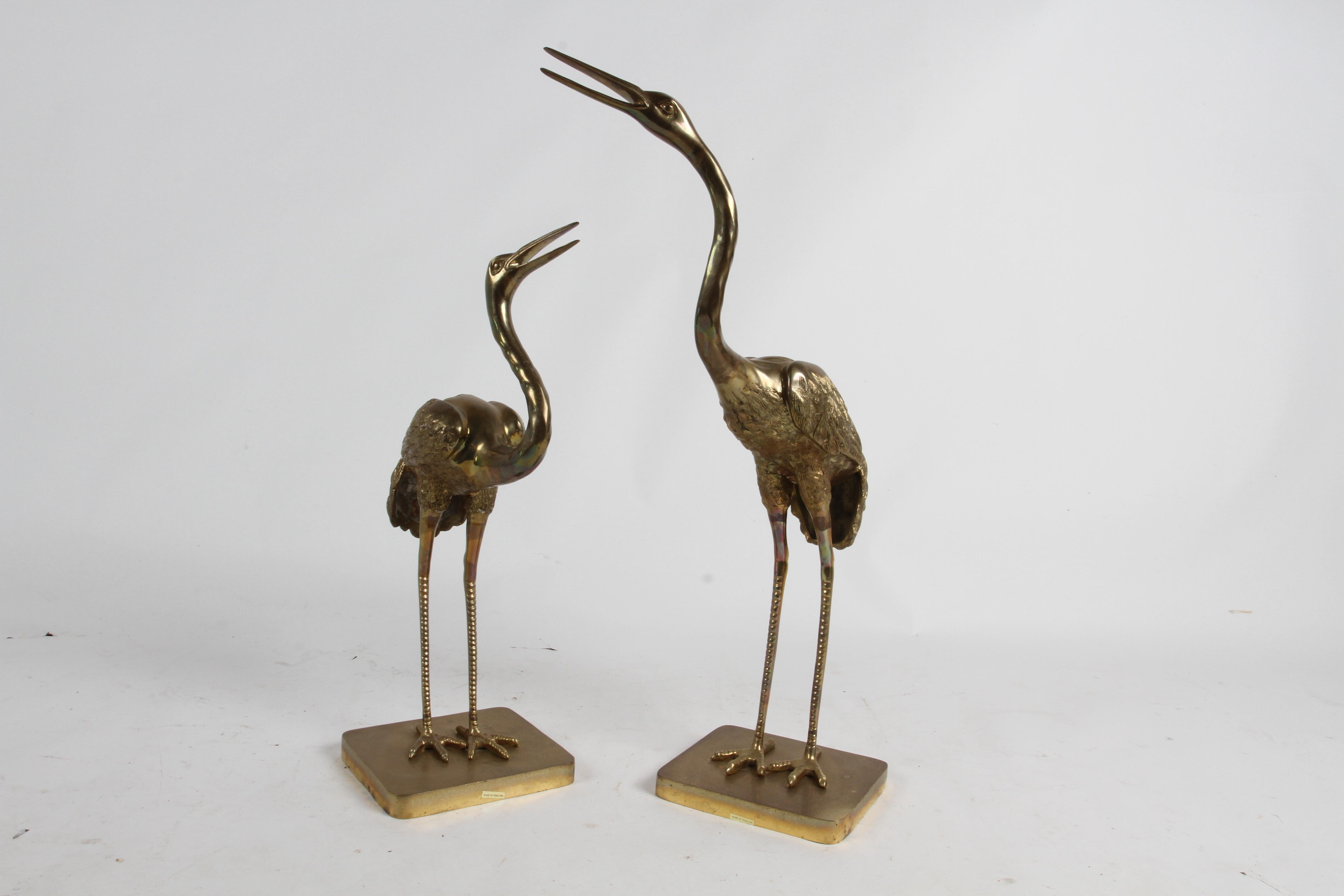 Pair of Hollywood Regency large brass cranes sculptures on square bases. These 1970s mid-century brass crane statues are well detailed and make great decorative accessories. Great patina. 

Large Crane 31.5