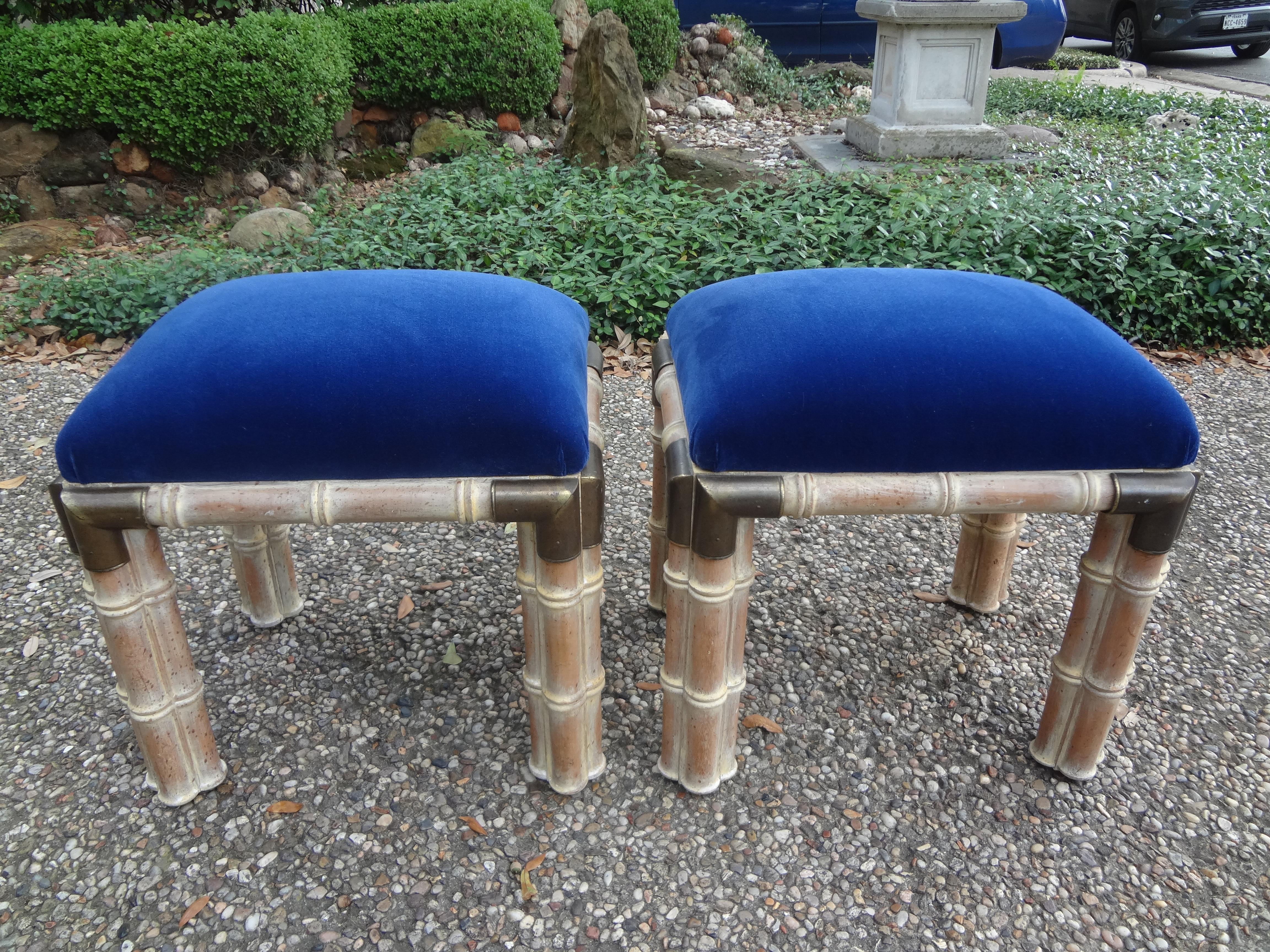 Stunning pair of Hollywood Regency faux bamboo wood ottomans with brass corners. These gorgeous and comfortable mid-century ottomans, benches or stools have been taken down to the frames and professionally upholstered in dark blue mohair. This