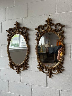 Pair of Hollywood Regency Gilt Rococo Oval Wall Mirrors in the French Taste