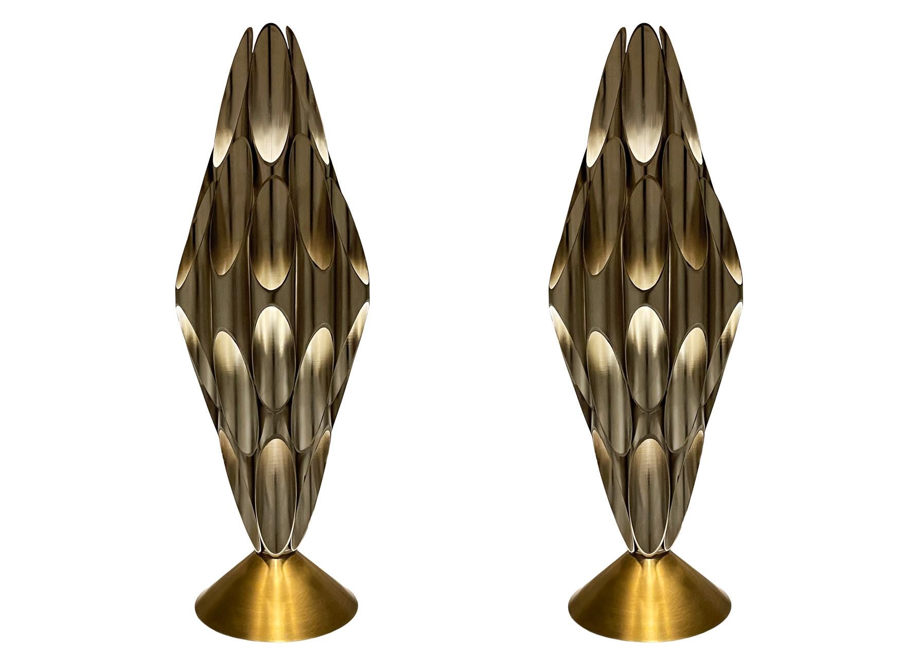 A pair of striking & chic tubular table lamps made by Designline. These feature heavy brass and nickel construction. Nice warm accent lighting. Takes one standard bulb. Cord is very long with built in switch.