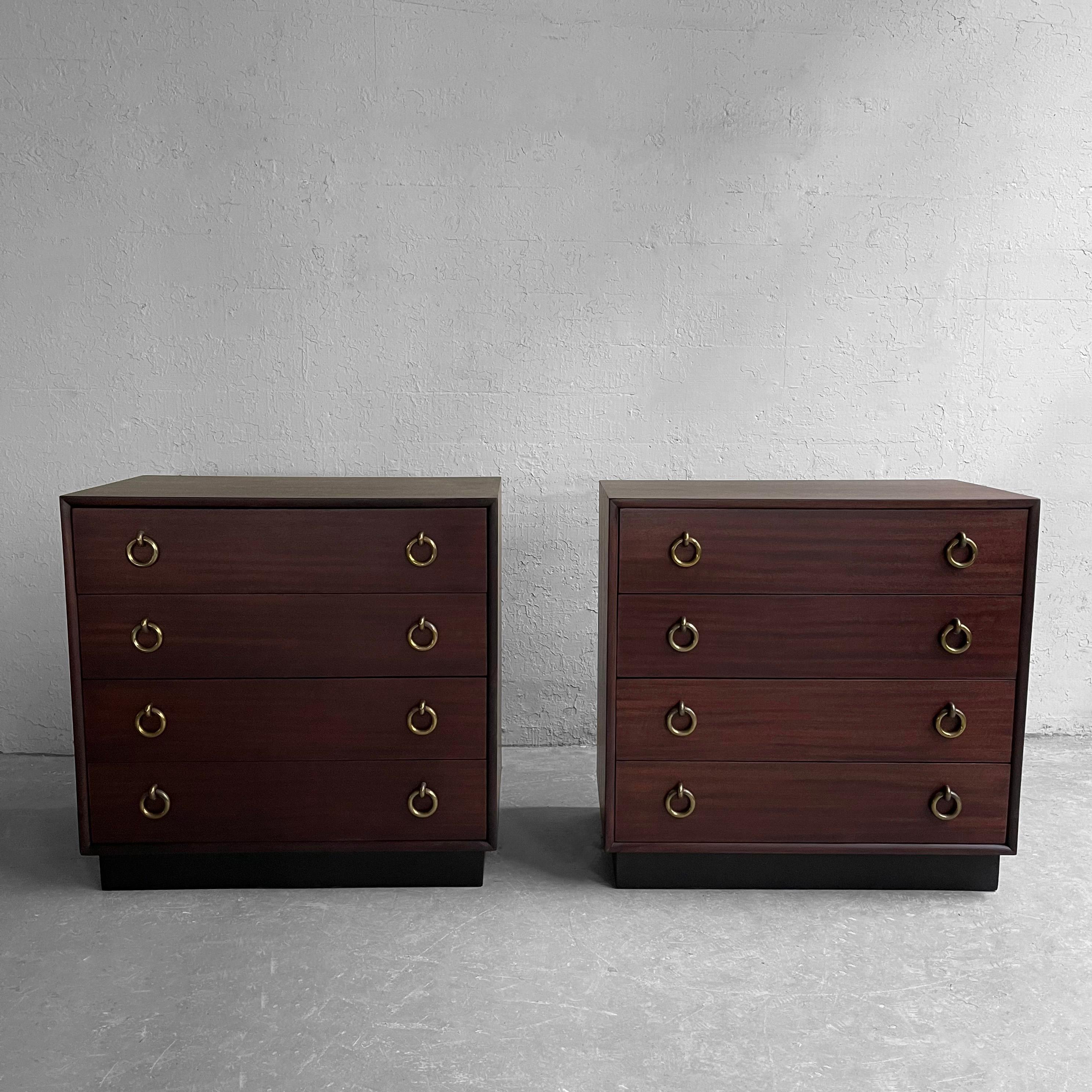 Pair of matched, Hollywood Regency, mahogany, 5 drawer dressers attributed to Gilbert Rohde with prominent brass ring pulls are newly finished in satin rosewood. The drawers measure 6.75