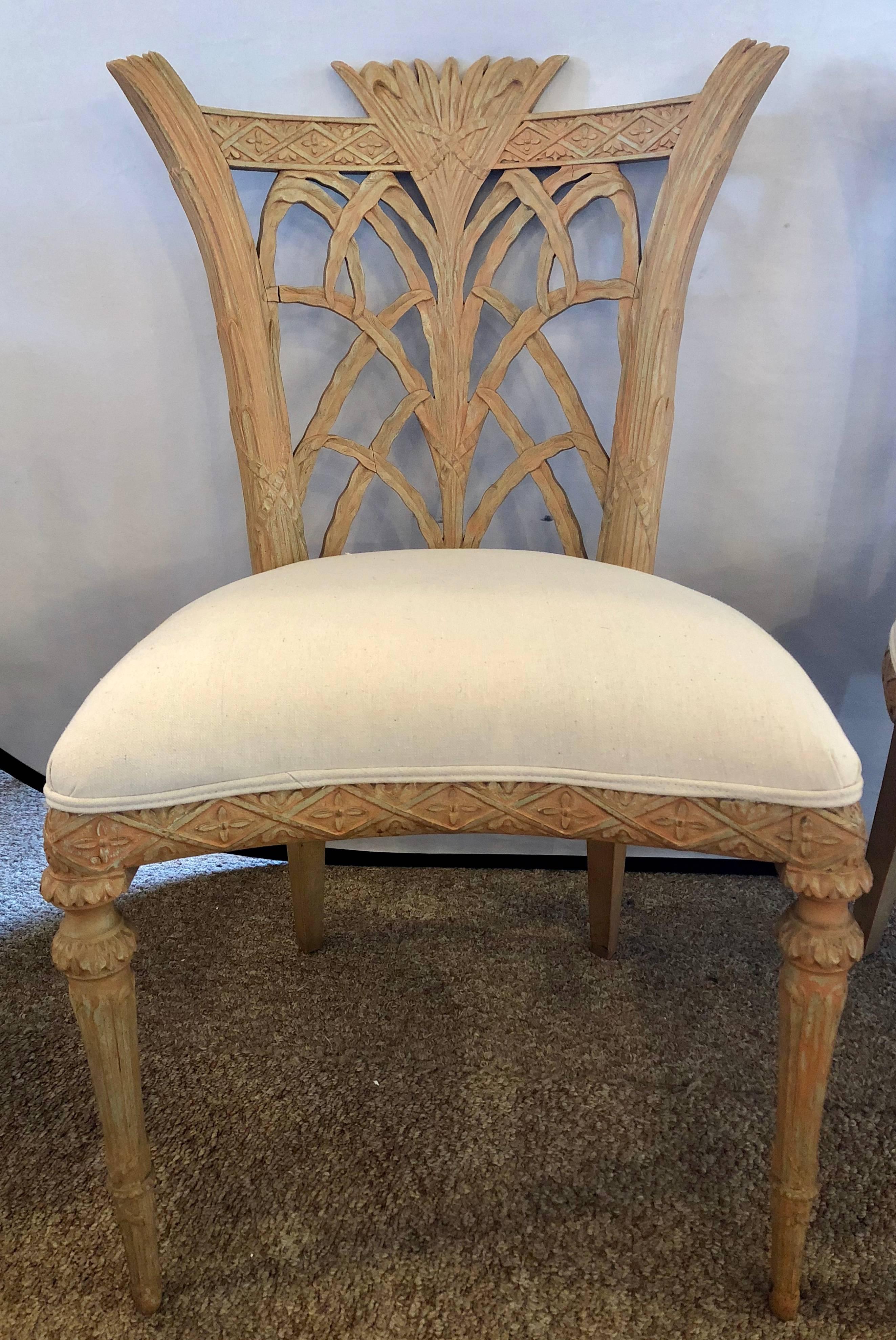 Pair of Hollywood Regency Maison Jansen palm tree form carved side chairs. A fine pair of newly upholstered side chairs by Jansen. Each having Louis XVI style legs supporting a carved back the whole done in a palm tree fashion with X design on the