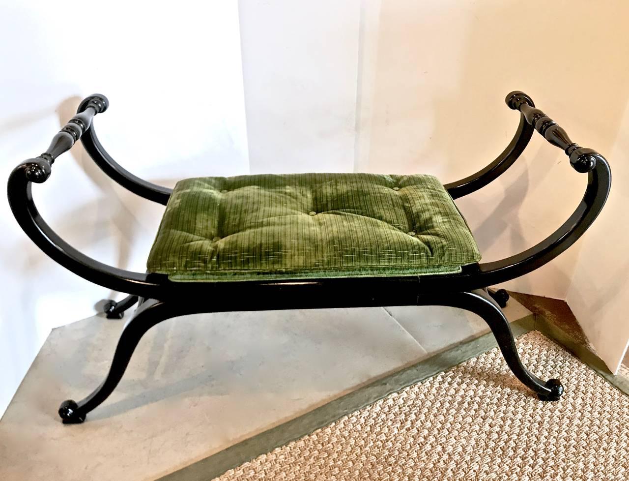 This is an unusual pair of midcentury Hollywood Regency black lacquered window seats that retain their original rich green Italian stripe silk upholstery. The benches are highly decorative and would be perfect at the end of a bed, in front of a