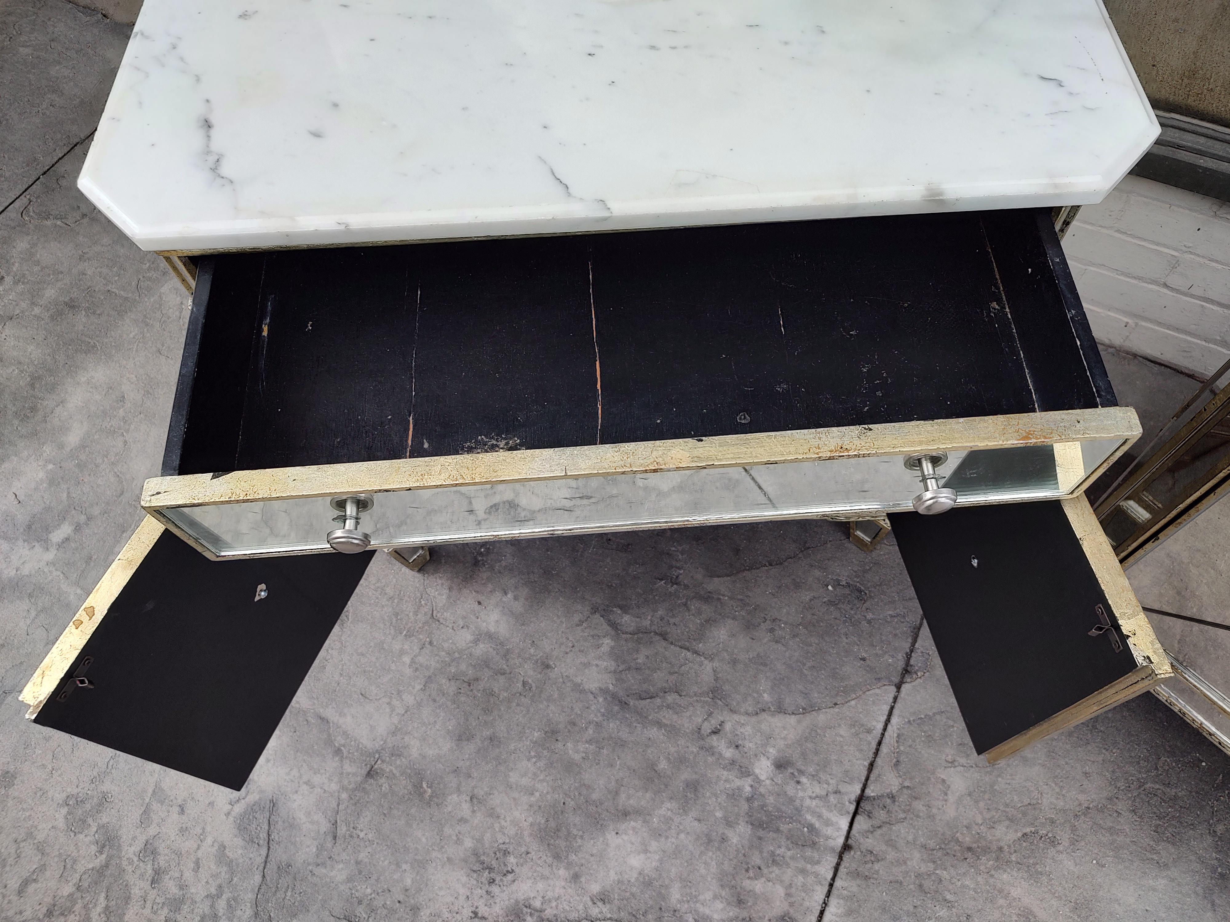 Fabulous pair of Hollywood Regency mirrored night tables with marble tops. One drawer over 2 doors for storage. In very good condition with minimal wear, some rings to the marble see pics or the video. Stainless hardware. Sold as a set.