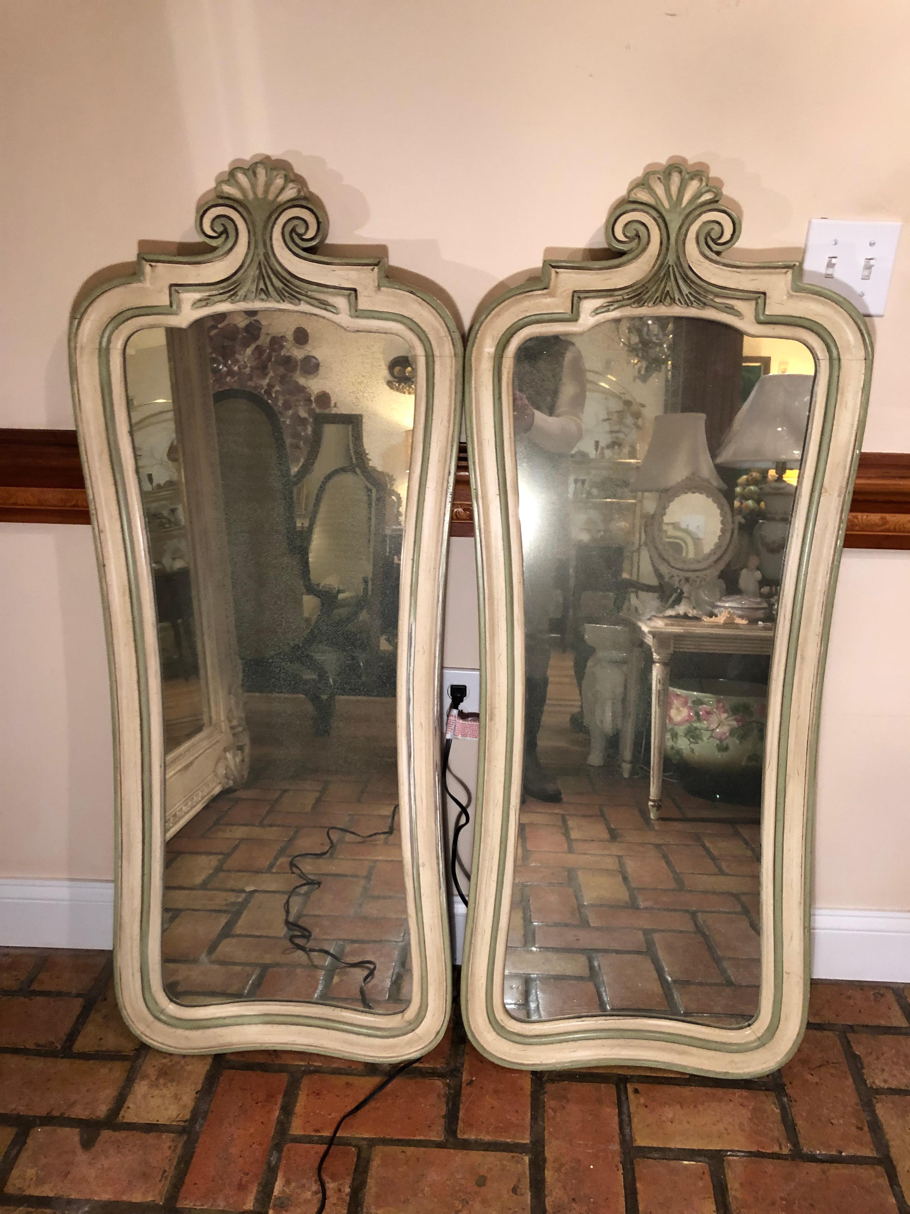 Pair of Hollywood Regency mirrors. Fabulous mercury like tint to these vintage mirrors. Great for above  master bathroom sinks. Please request a parcel quote from the seller or 1stdibs . Please provide your zip code. 

