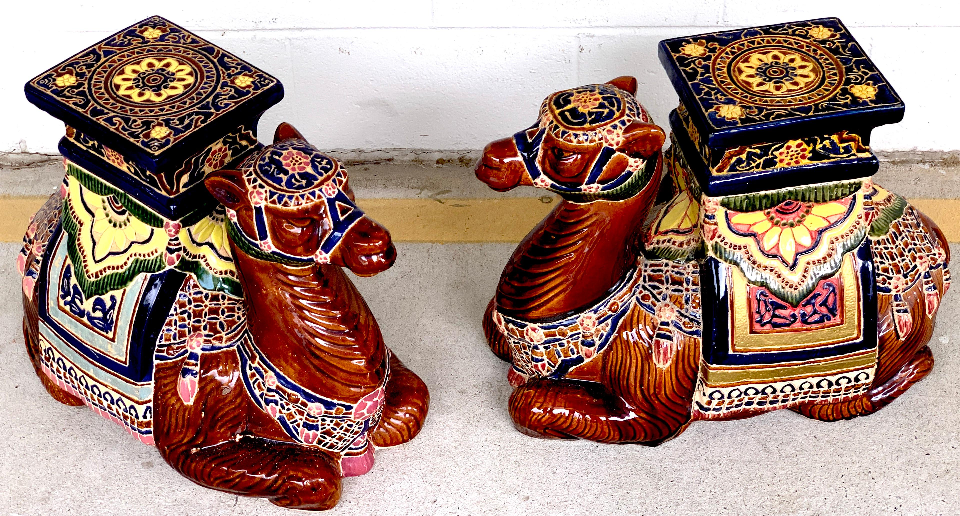 Pair of Hollywood Regency Moorish Majolica camel garden seats, vibrantly decorated of a seated saddled camel with 8.5 x 7