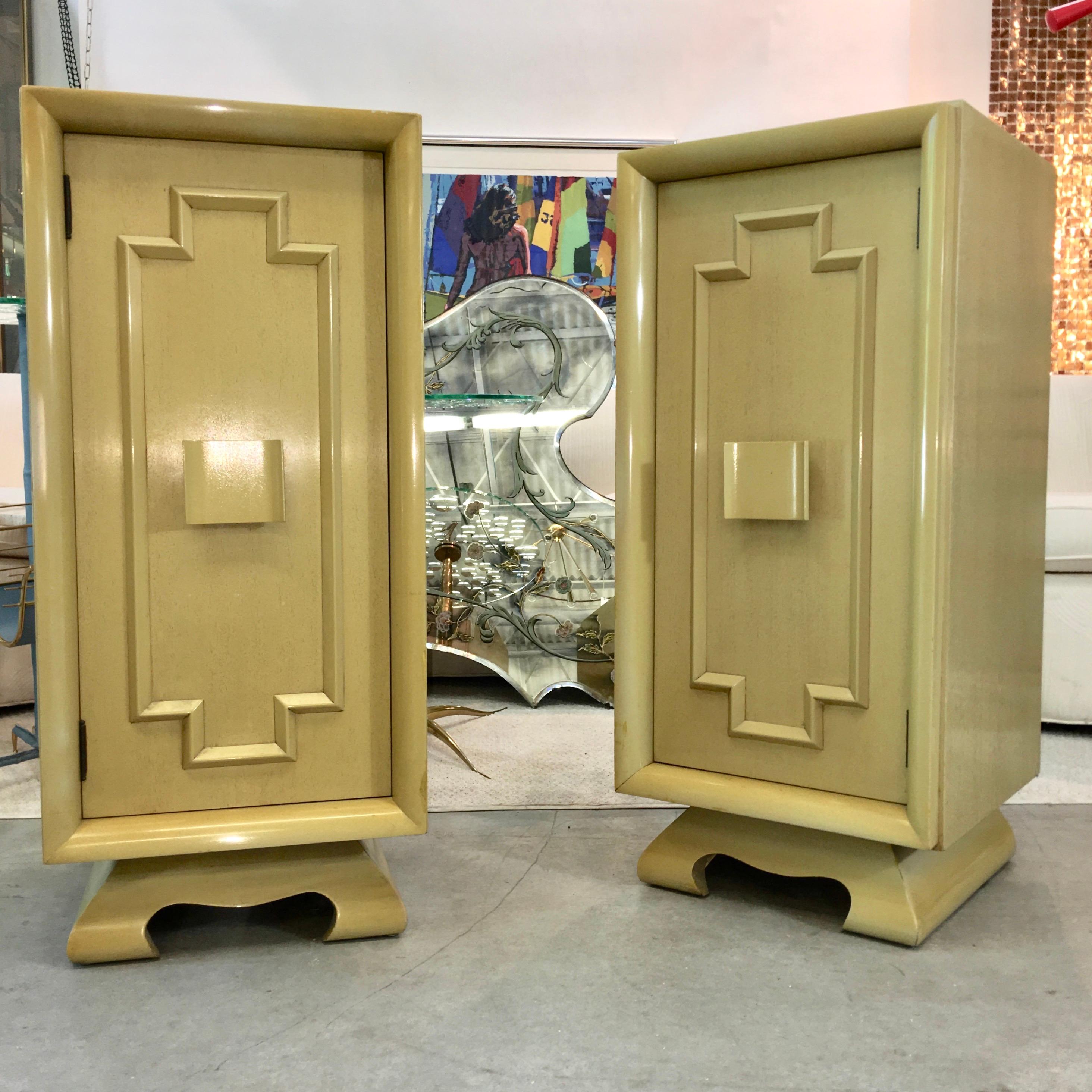 Pair of tall and slim vintage bedside cabinets in Asian modernist form popularized by James Mont and the Kittinger Mandarin collection. Note the pagoda form feet and geometric moulding on the doors as well as the stylish central medallion pull.